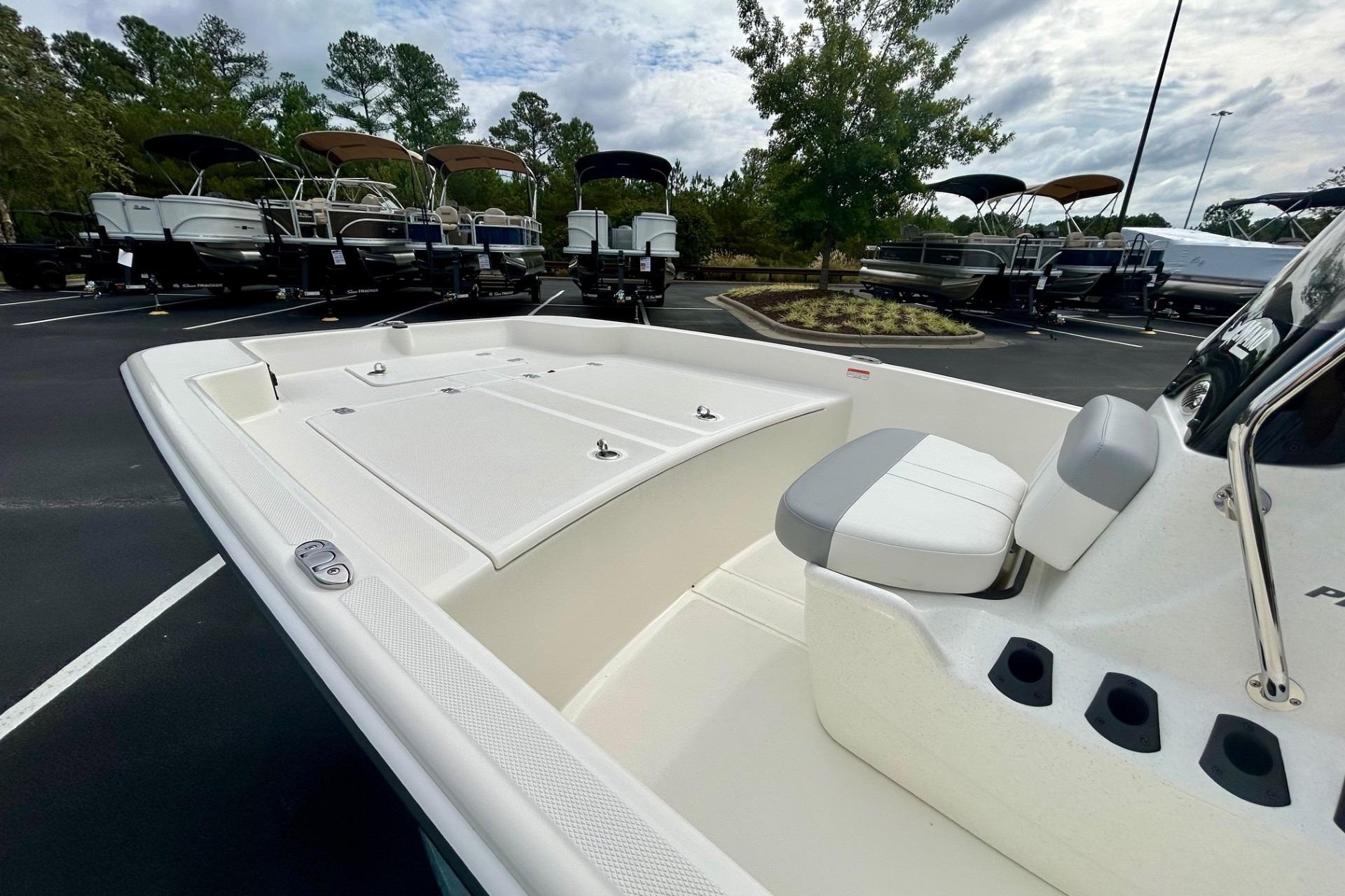 2026 Mako Pro Skiff 17 CC boat interior with seating, parked outdoors.