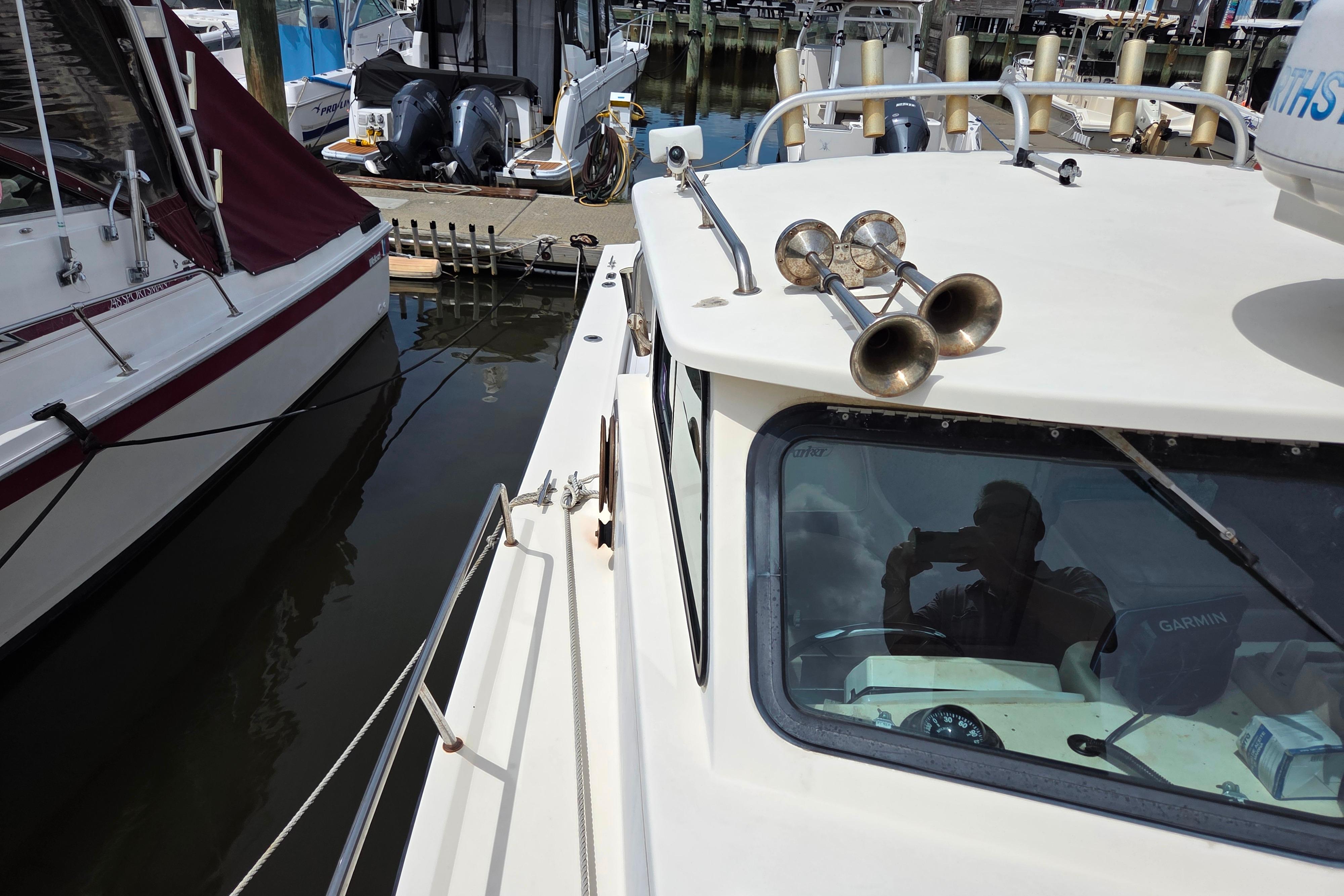 2002 Parker 2520 Deep Vee Sport Cabin docked, featuring cabin and deck details.