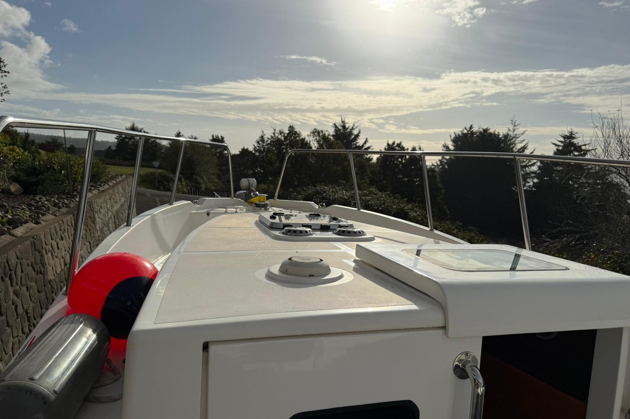 2020 SeaPiper 35 boat deck under a bright sky, surrounded by trees.