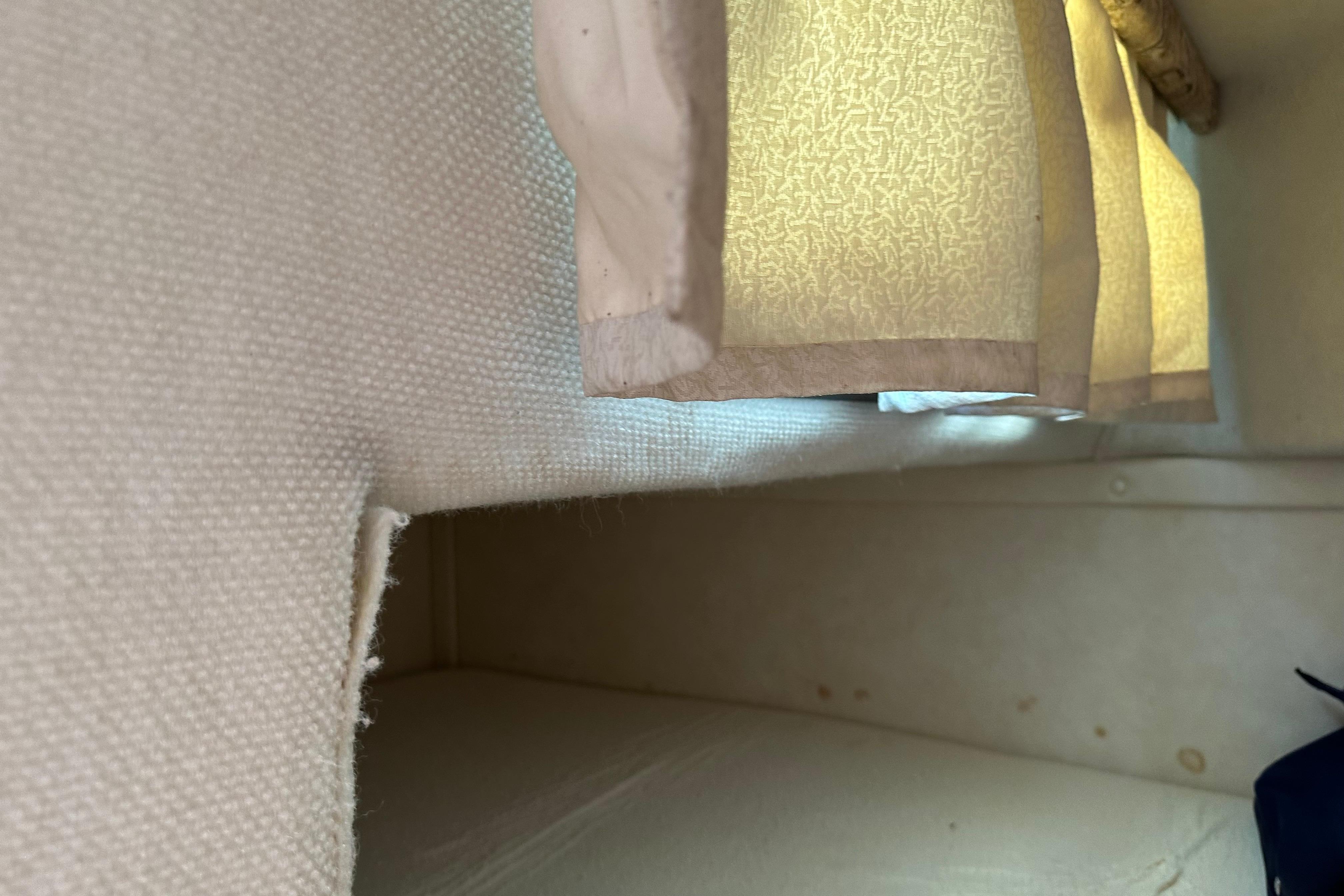 Interior cabin view of a 1999 Monterey 262 Cruiser with beige curtains.