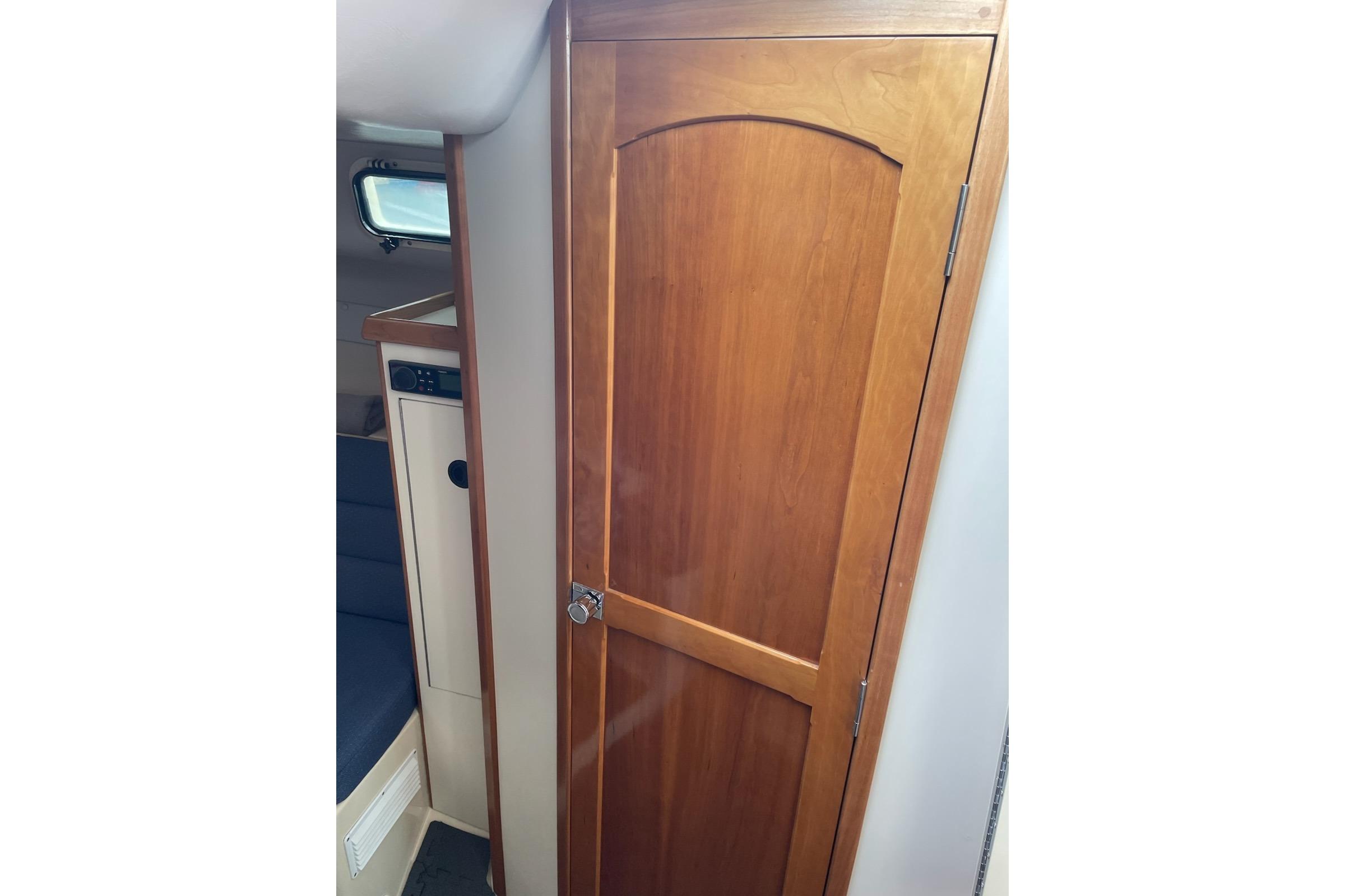 Interior view of 2003 Albin 28 Tournament Express with wooden cabin door.