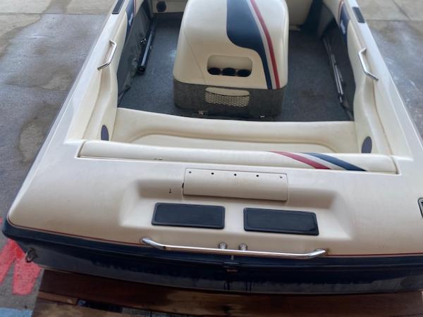 1998 Malibu Response boat interior with white seating and red-blue accents.