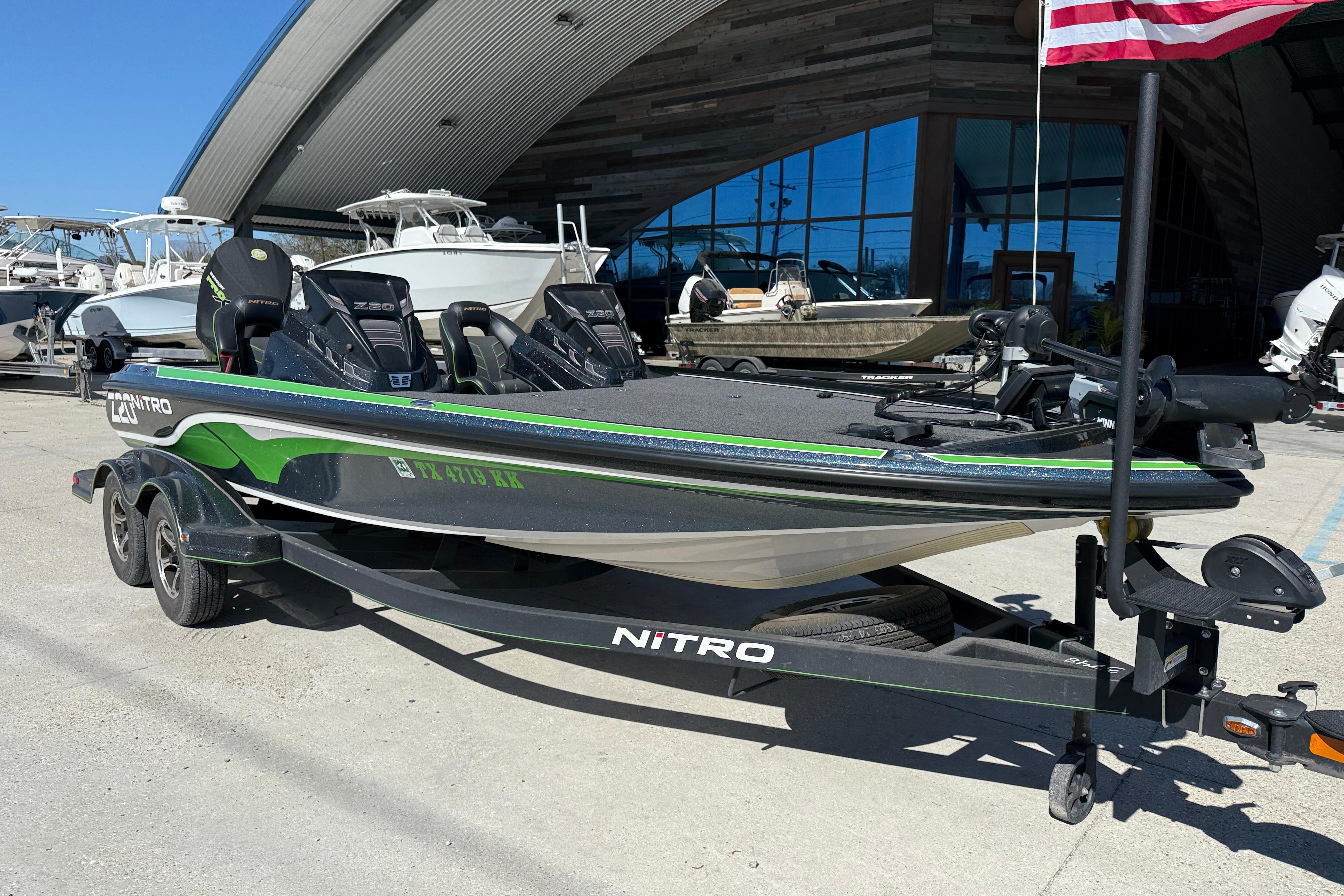 2020 Nitro Z20 boat on trailer, parked outside a modern building.