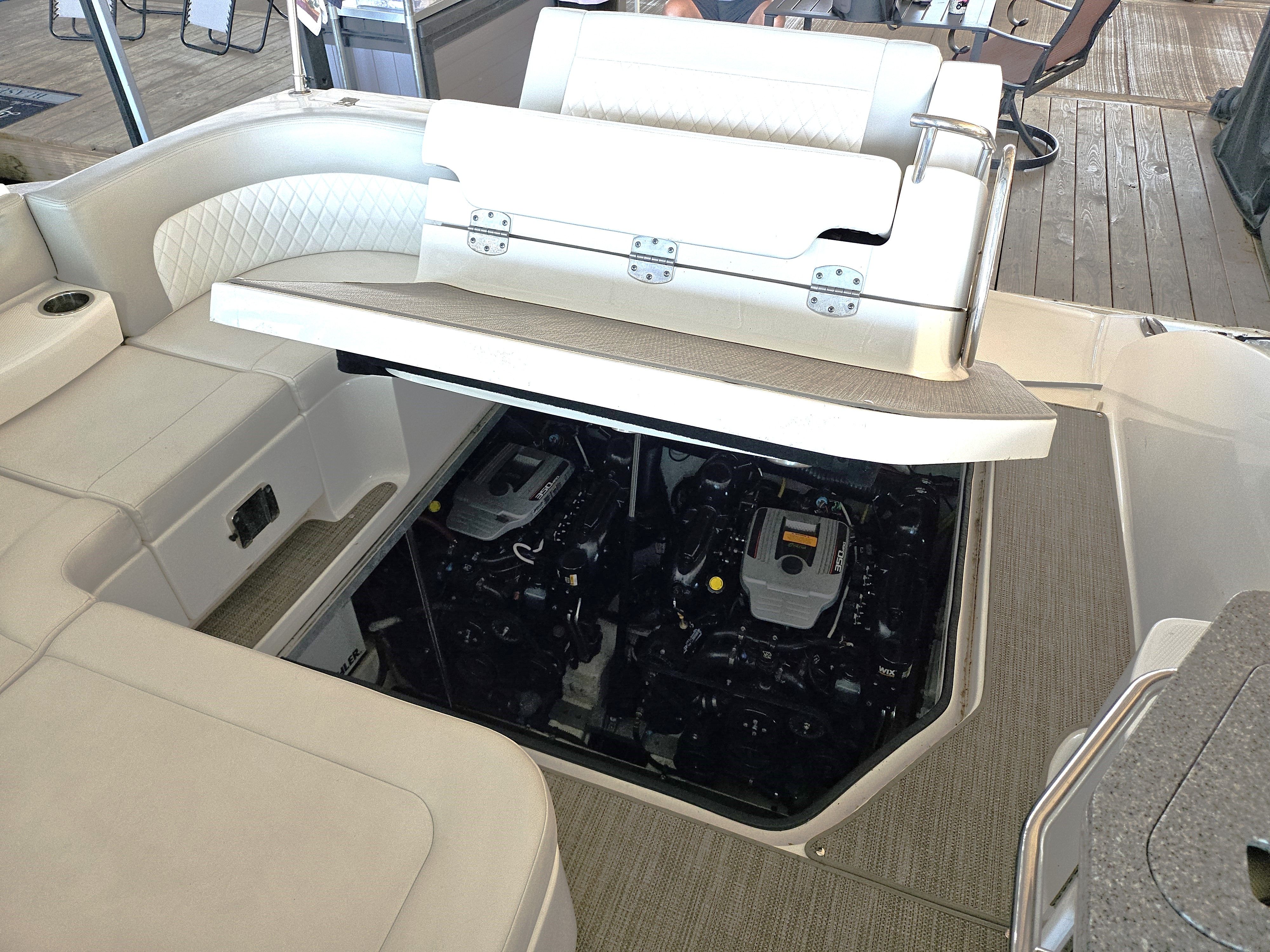 Engine compartment of 2014 Chaparral 330 Signature with open seating area.