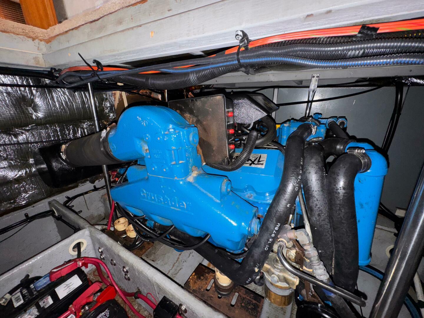 Engine compartment of a 1997 Silverton 352 Motor Yacht, featuring a blue Crusader engine.