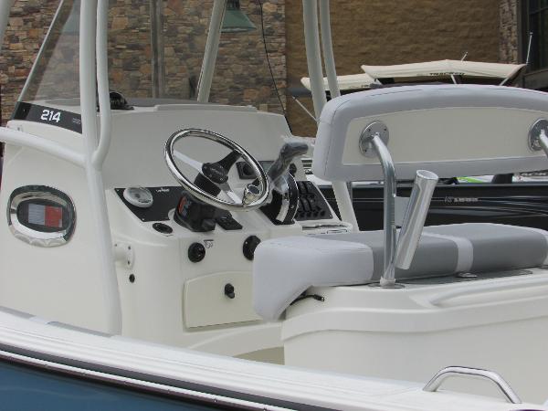 2023 Mako 214 CC boat interior with steering wheel and seating.
