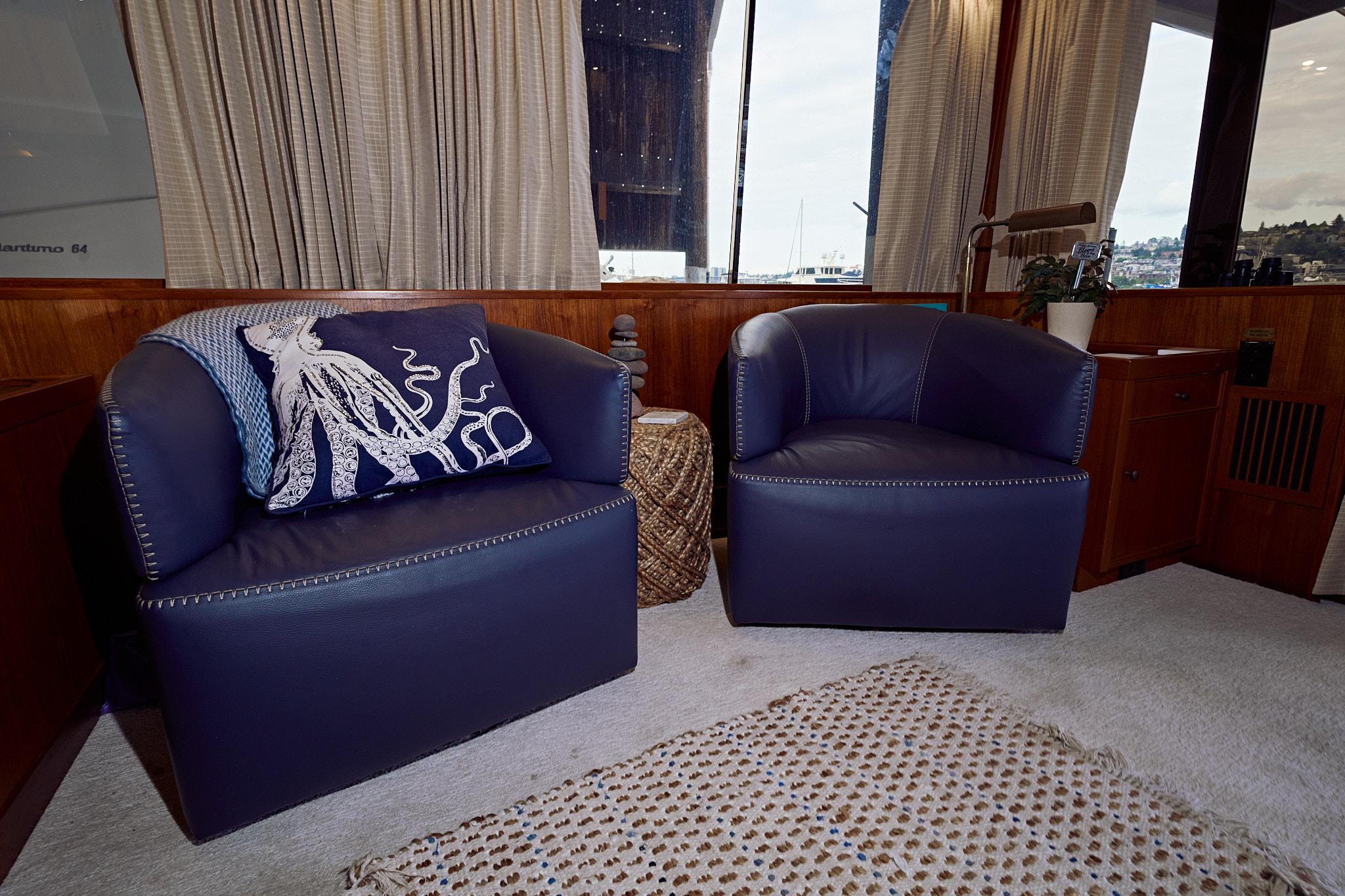 1976 Pacemaker 65 yacht interior with blue leather chairs and octopus pillow.