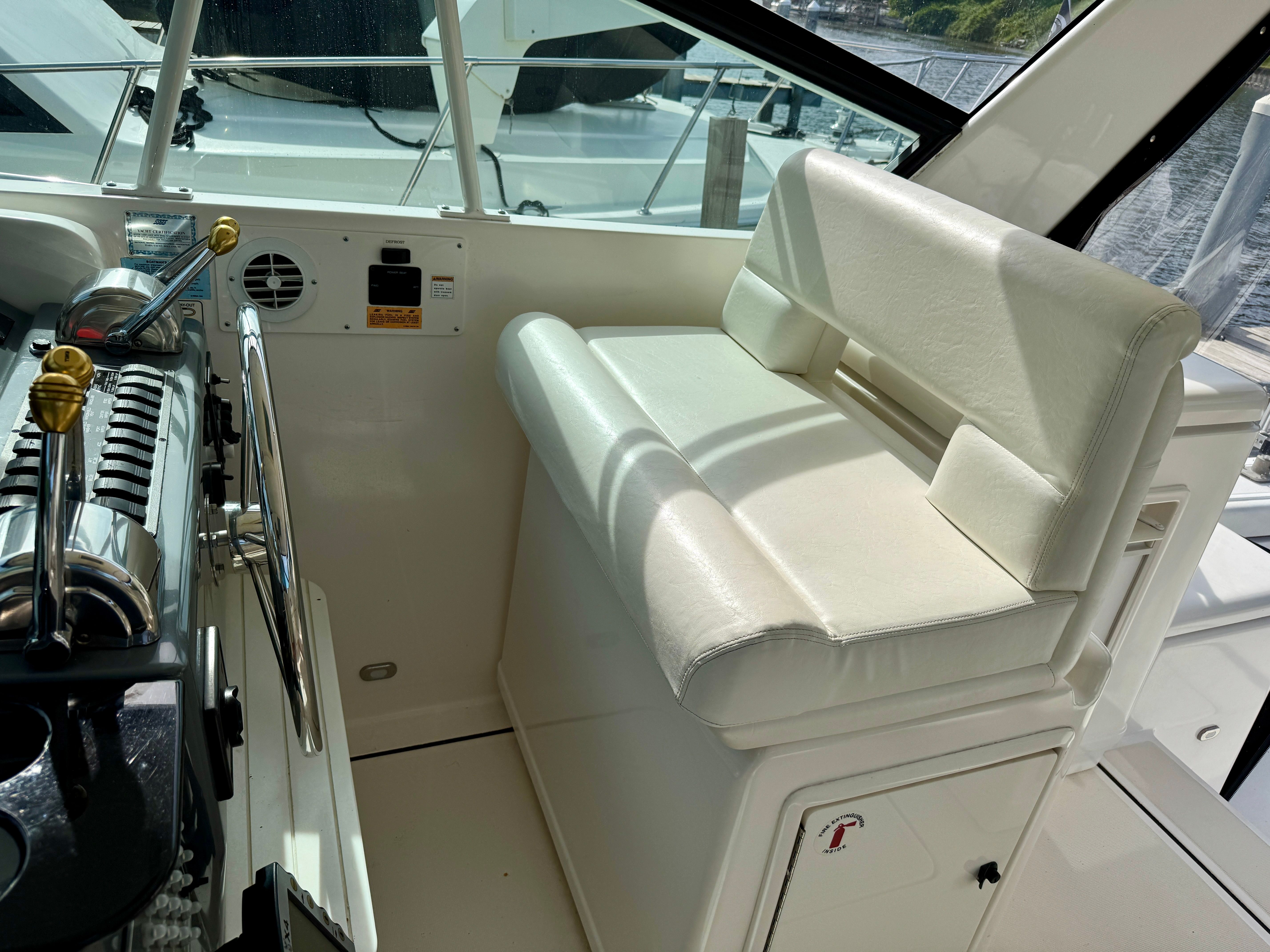 Interior of a 1999 Tiara Yachts 4100 Open, helm station with seating.