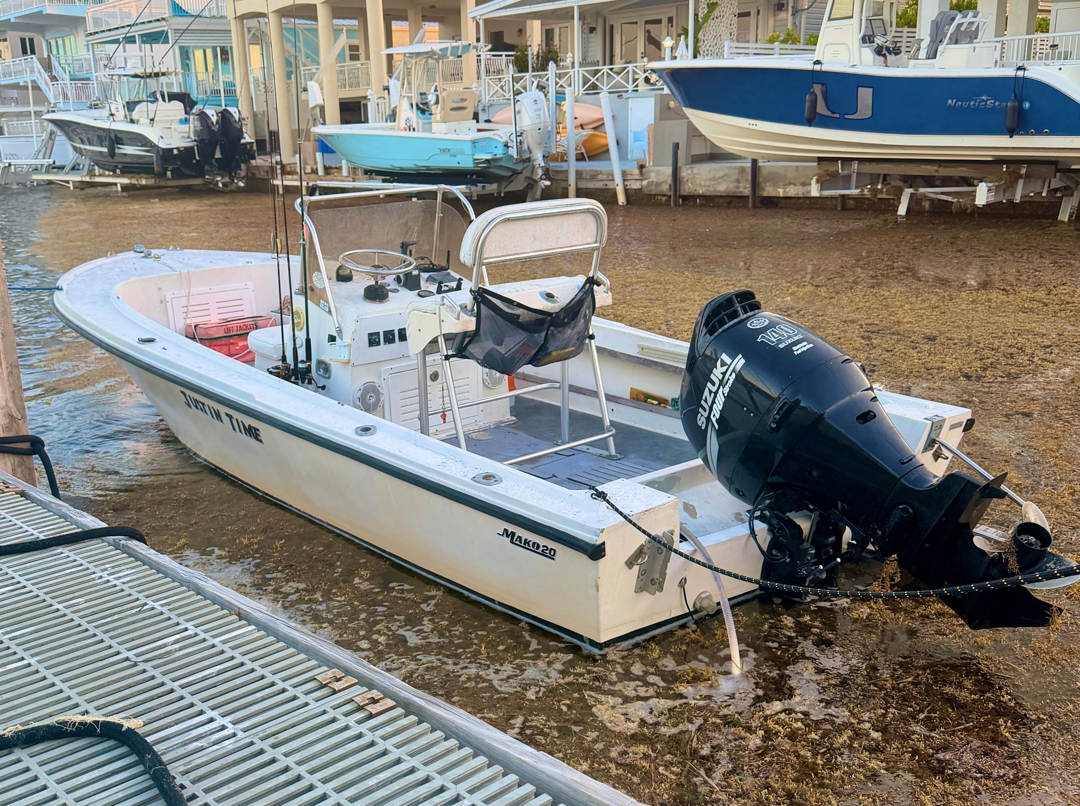 1970 Mako 20 boat with Suzuki outboard motor at dock.