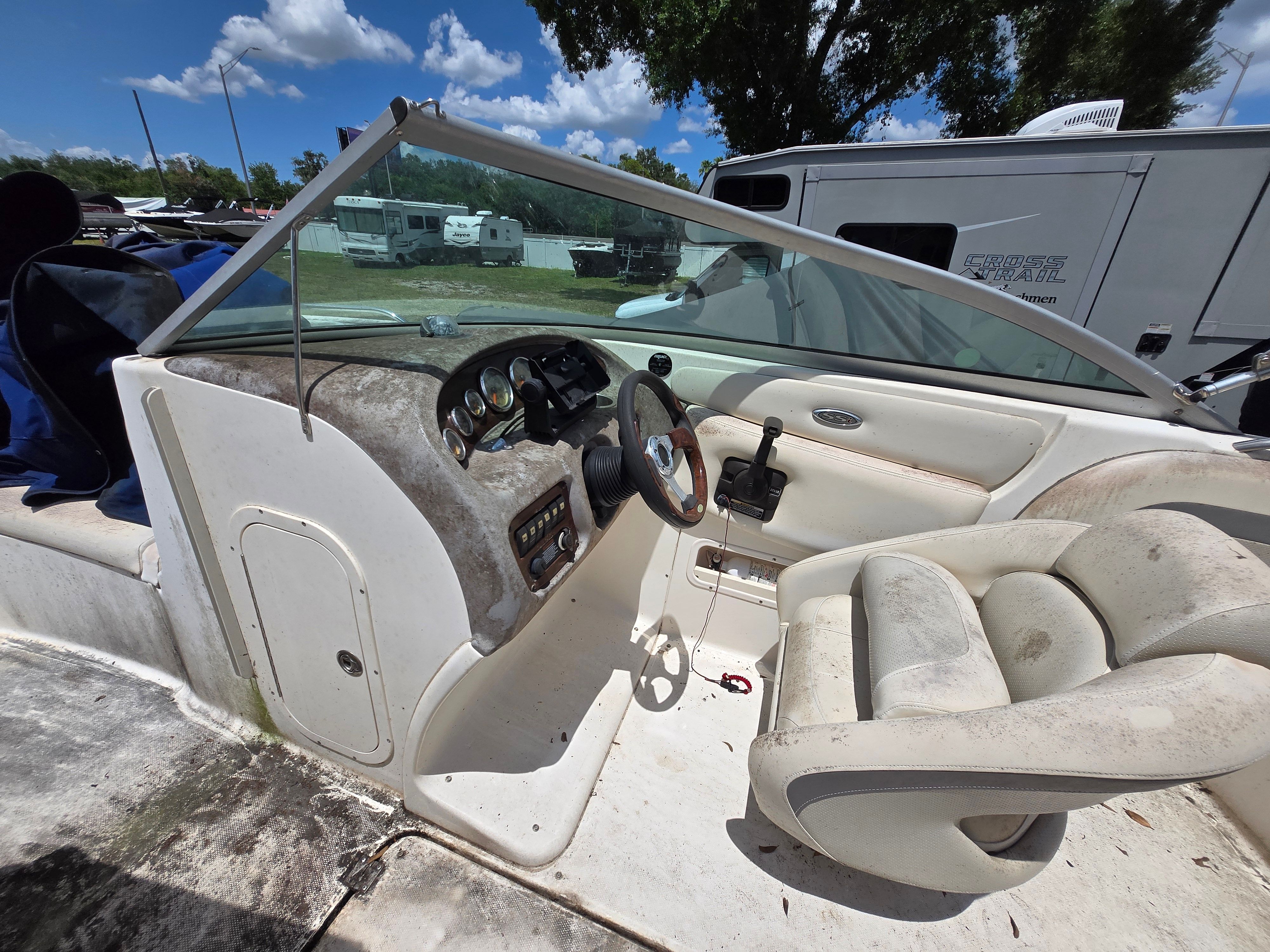 The image shows the cockpit of a 2006 Chaparral 220 SSi with worn seats.