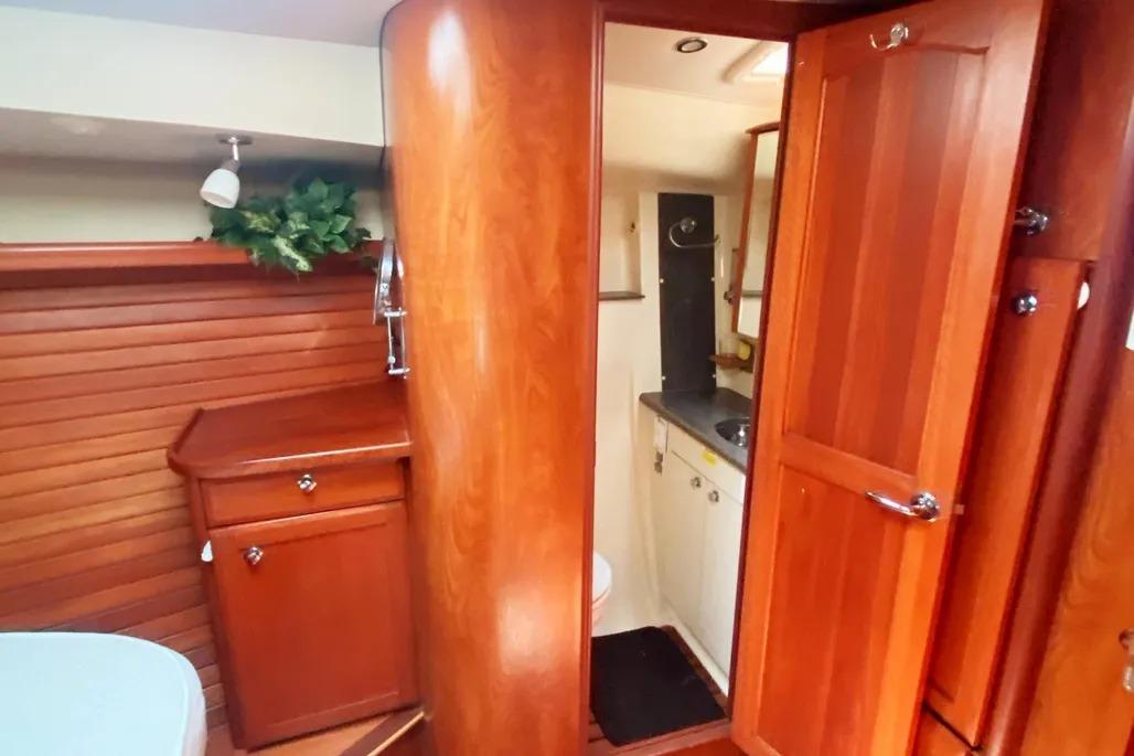 Interior of 2012 Hunter Aft Cockpit 50 yacht with wooden cabinetry and bathroom.