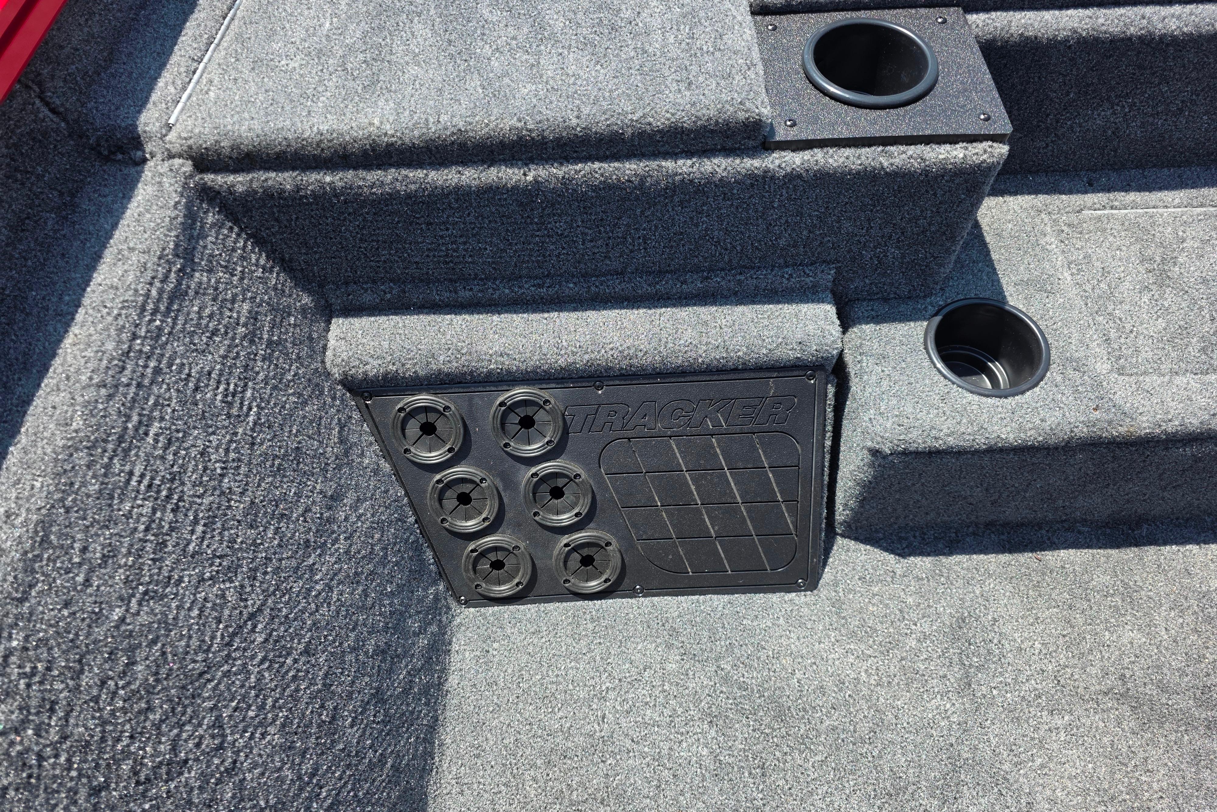 Interior of 2026 Tracker Pro Team 195 boat with cup holders and storage panel.