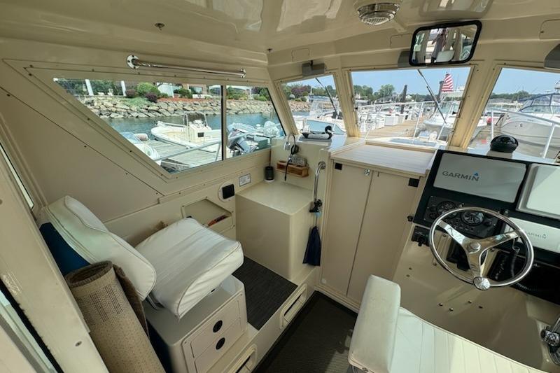 Interior of a 2003 Albin 28 Tournament Express boat with steering wheel and navigation equipment.