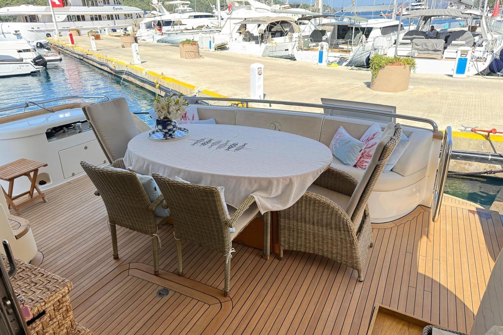 Luxury Evo Marine Deauville 76 yacht deck with elegant outdoor dining area, 2008 model.