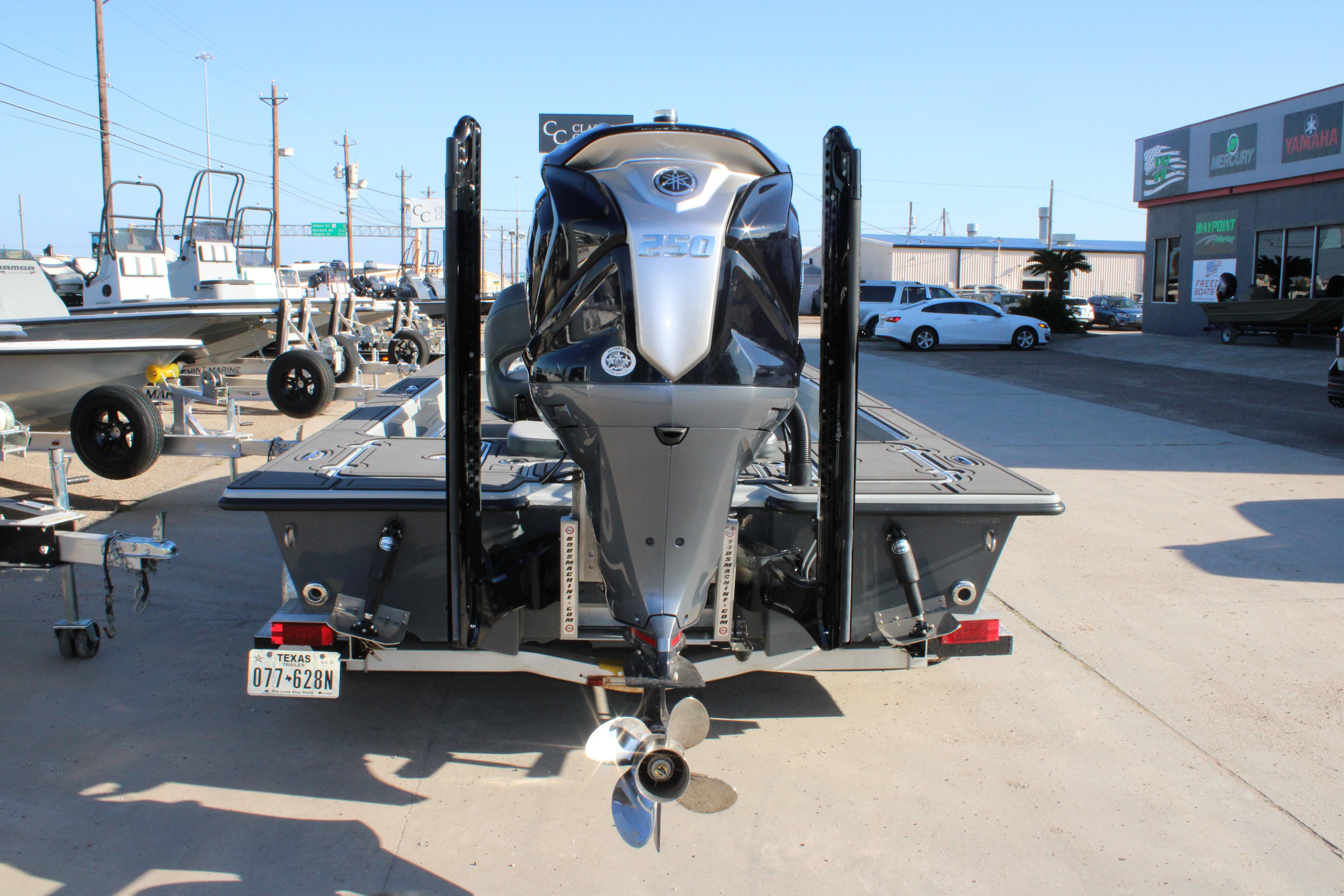 2025 Mamba 227VX boat with powerful outboard motor, displayed at a dealership.