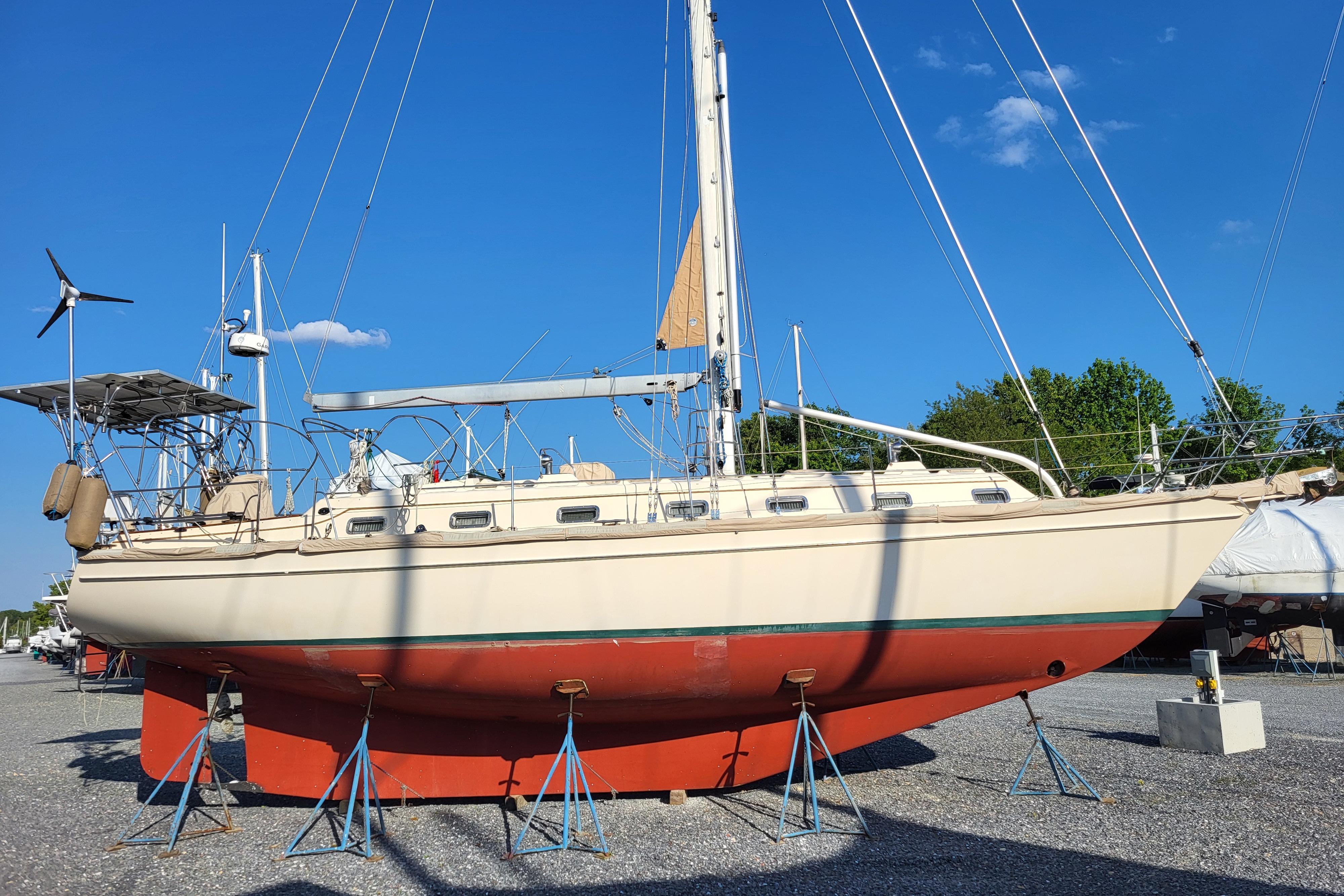 Island Packet 420 sailboat from 2000 on stands, clear blue sky background.