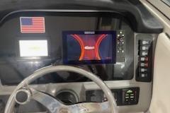 2022 Robalo R247 Dual Console dashboard with navigation display and American flag sticker.