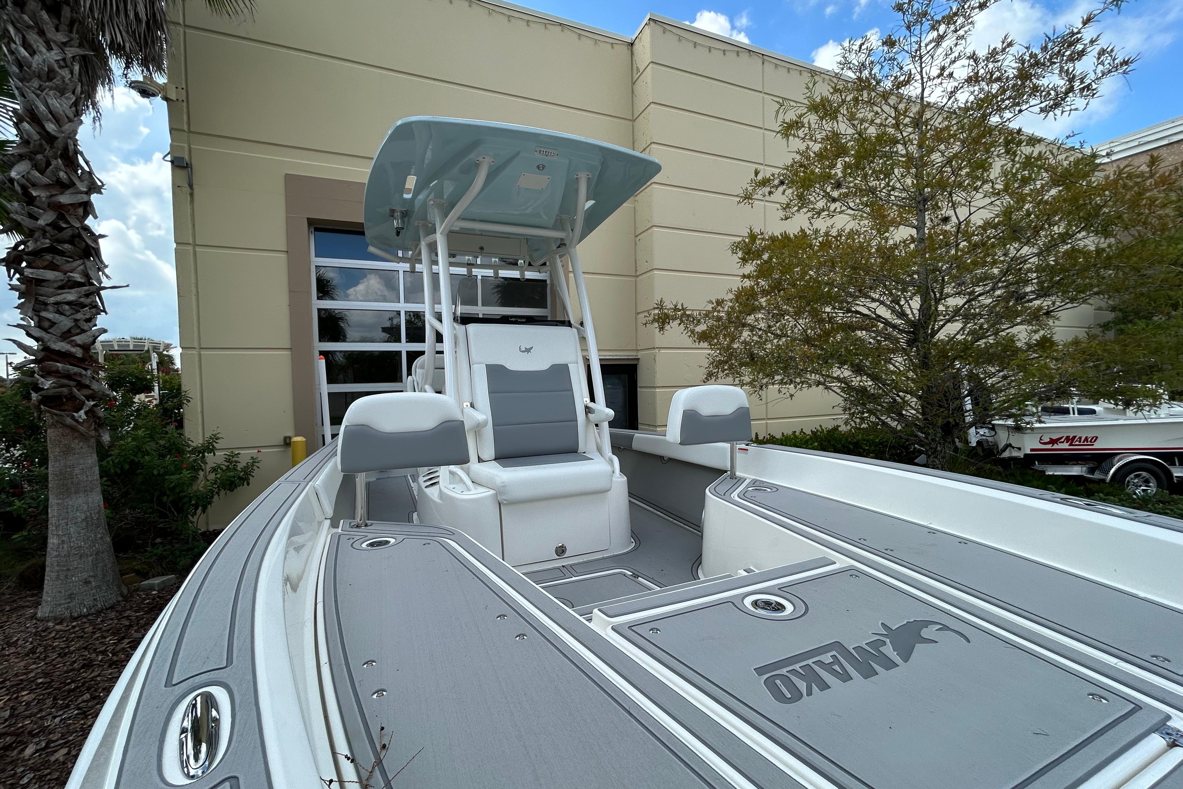 2025 Mako 24 APEX boat displayed outdoors, featuring sleek design and modern seating.
