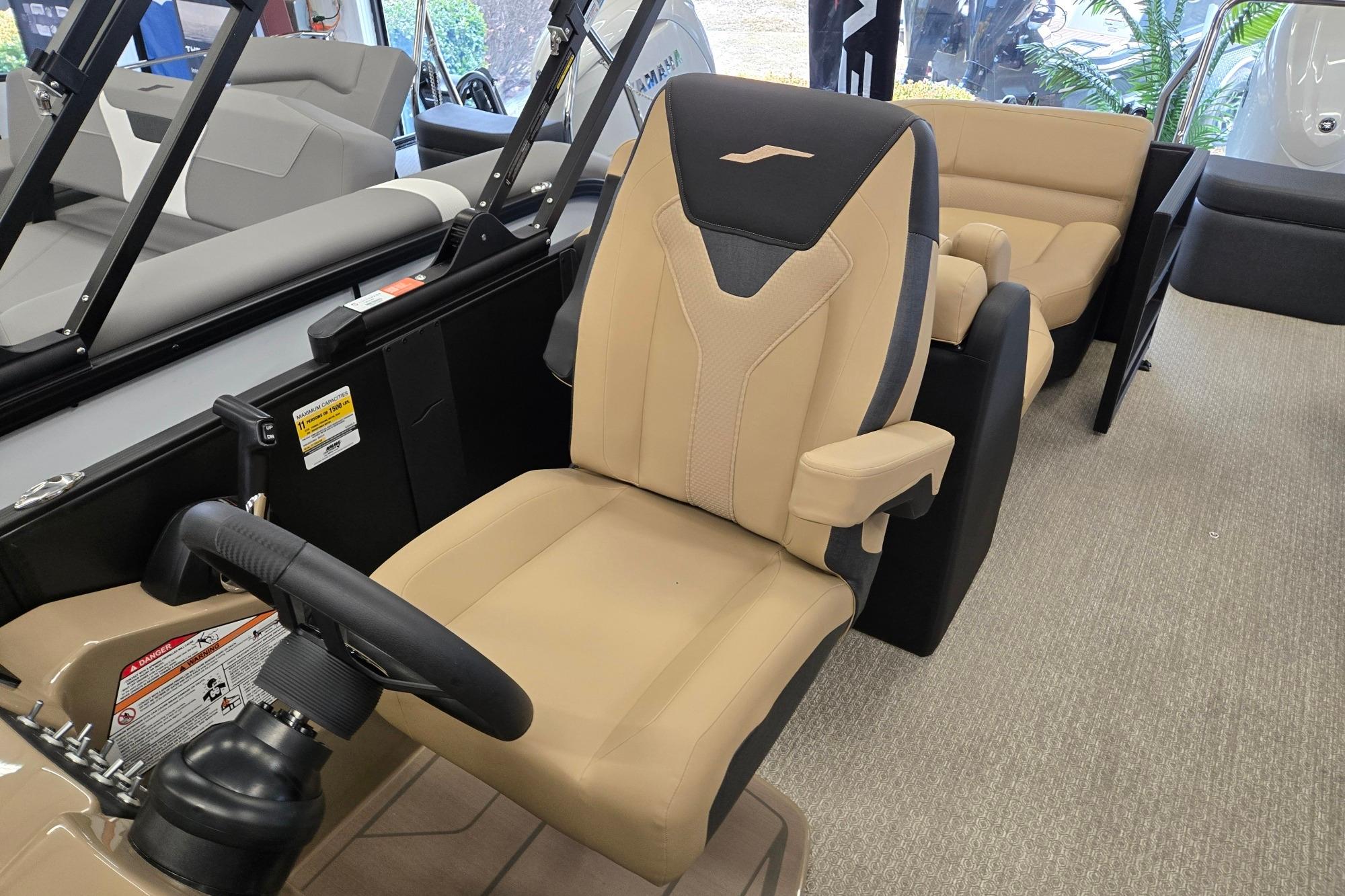 2026 Evotti 521QL boat interior with beige captain's chair and steering wheel.