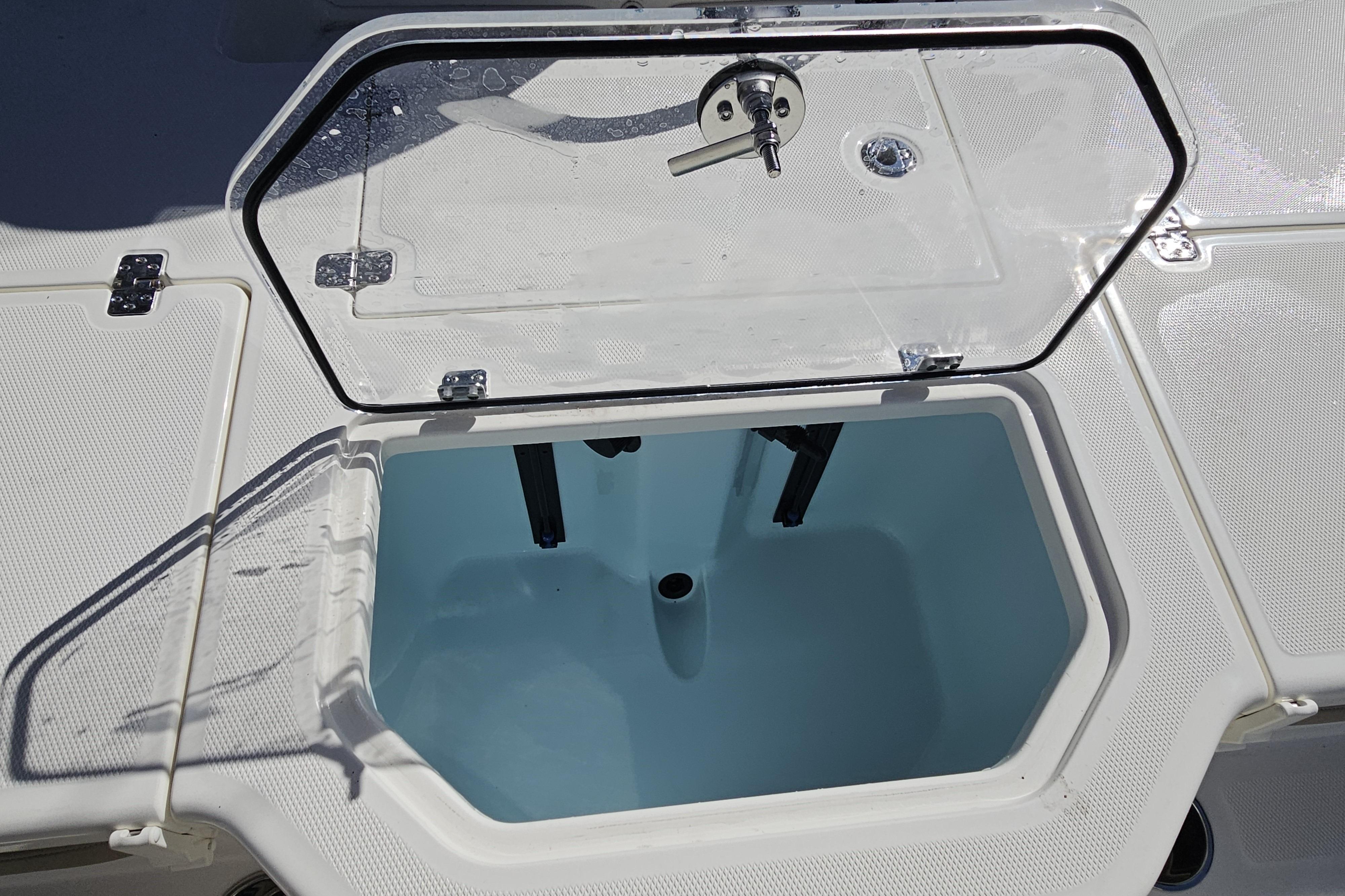 Open storage compartment on 2026 Mako Pro Skiff 19 CC boat deck.