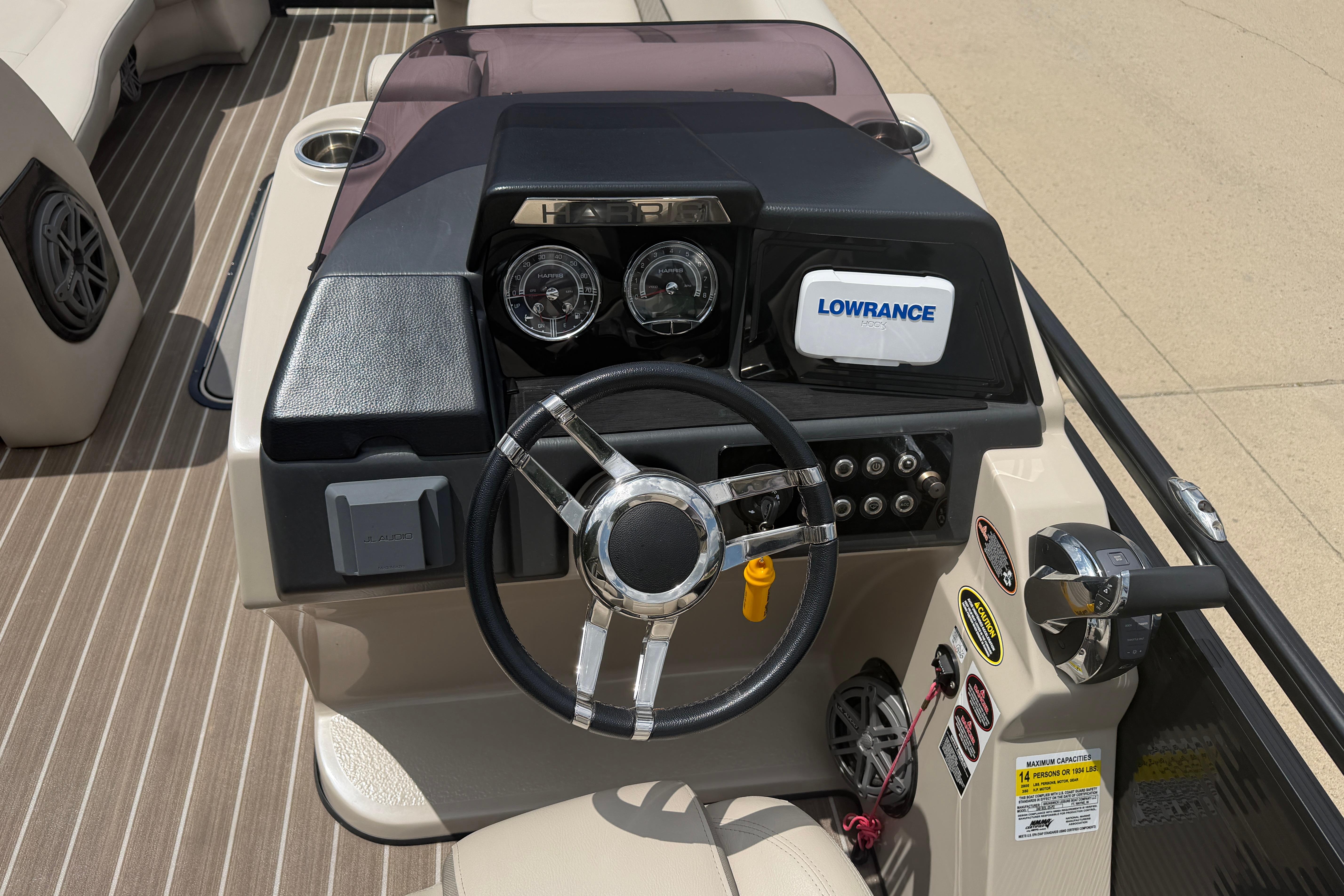 2019 Harris Solstice 240 boat dashboard with steering wheel, gauges, and Lowrance navigation system.