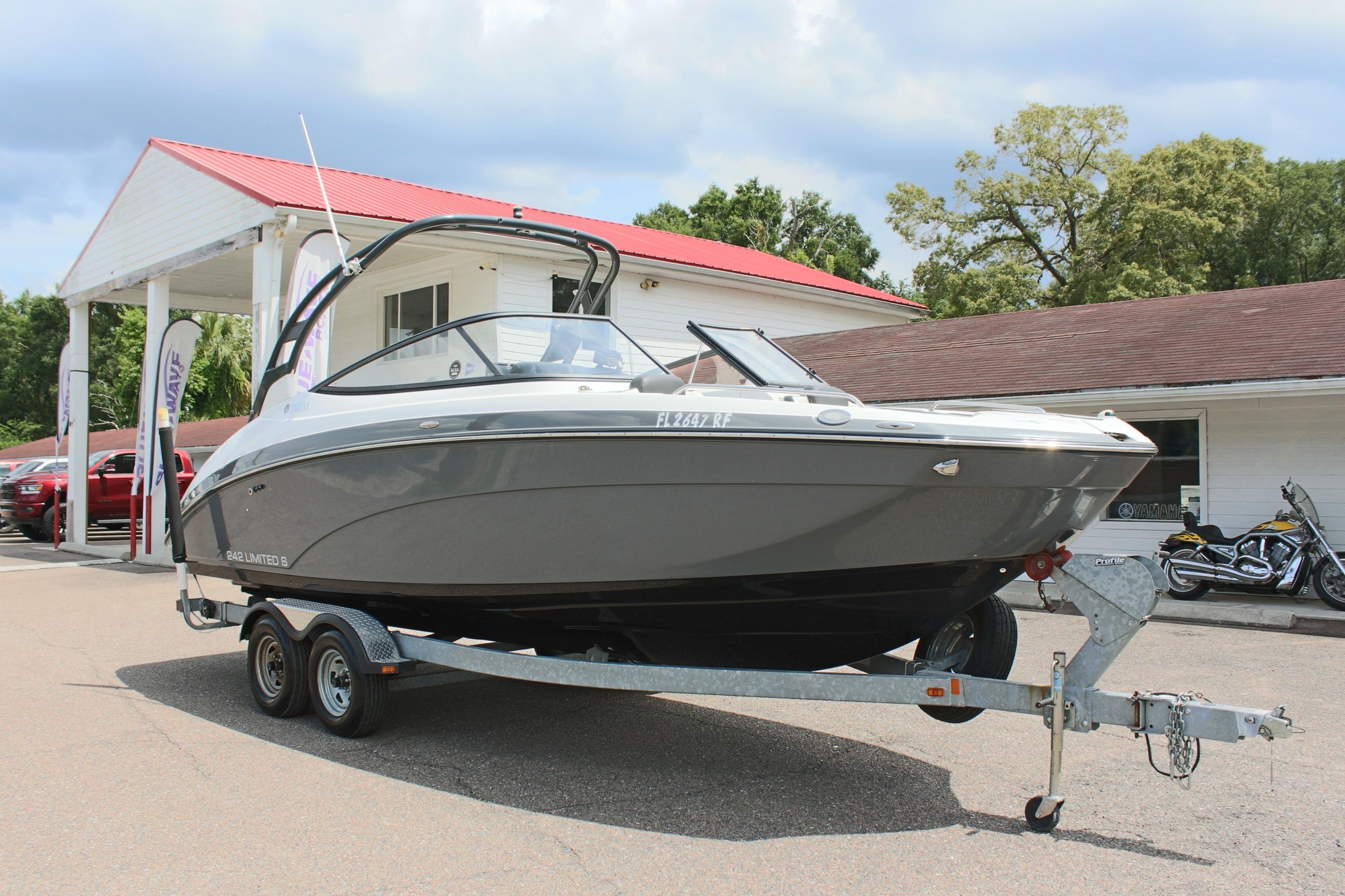 2016 Yamaha Boats 242 Limited S on trailer, parked outside dealership.