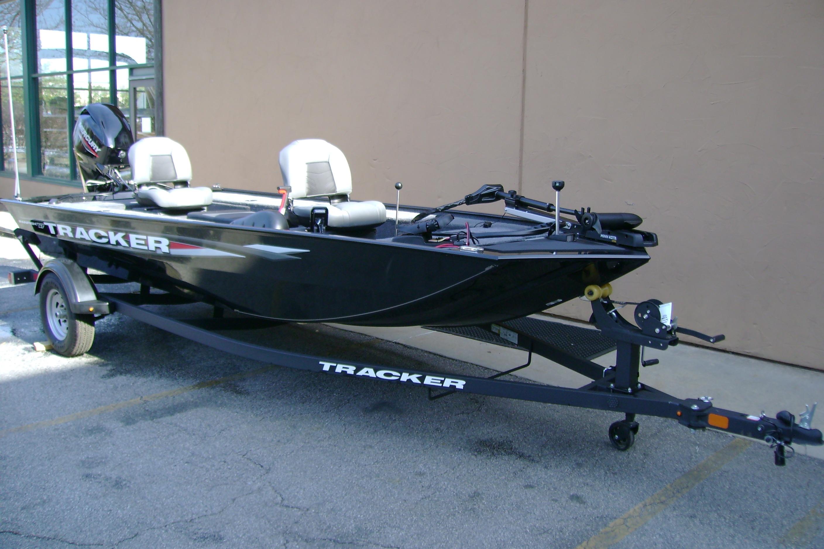 2026 Tracker Panfish 17 boat on trailer, parked outdoors, featuring dual seats and motor.
