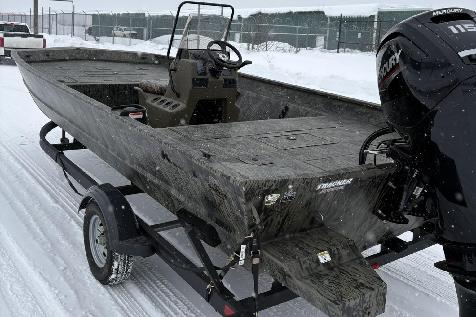 2025 Tracker Grizzly 2072 CC boat on snowy trailer, featuring Mercury engine.