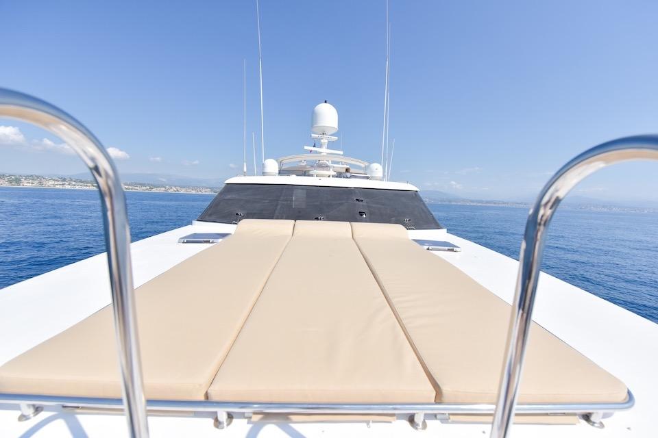 Luxury yacht deck with sunbed, W.A. Souter & Sons 34, 1984 model, cruising on calm sea.