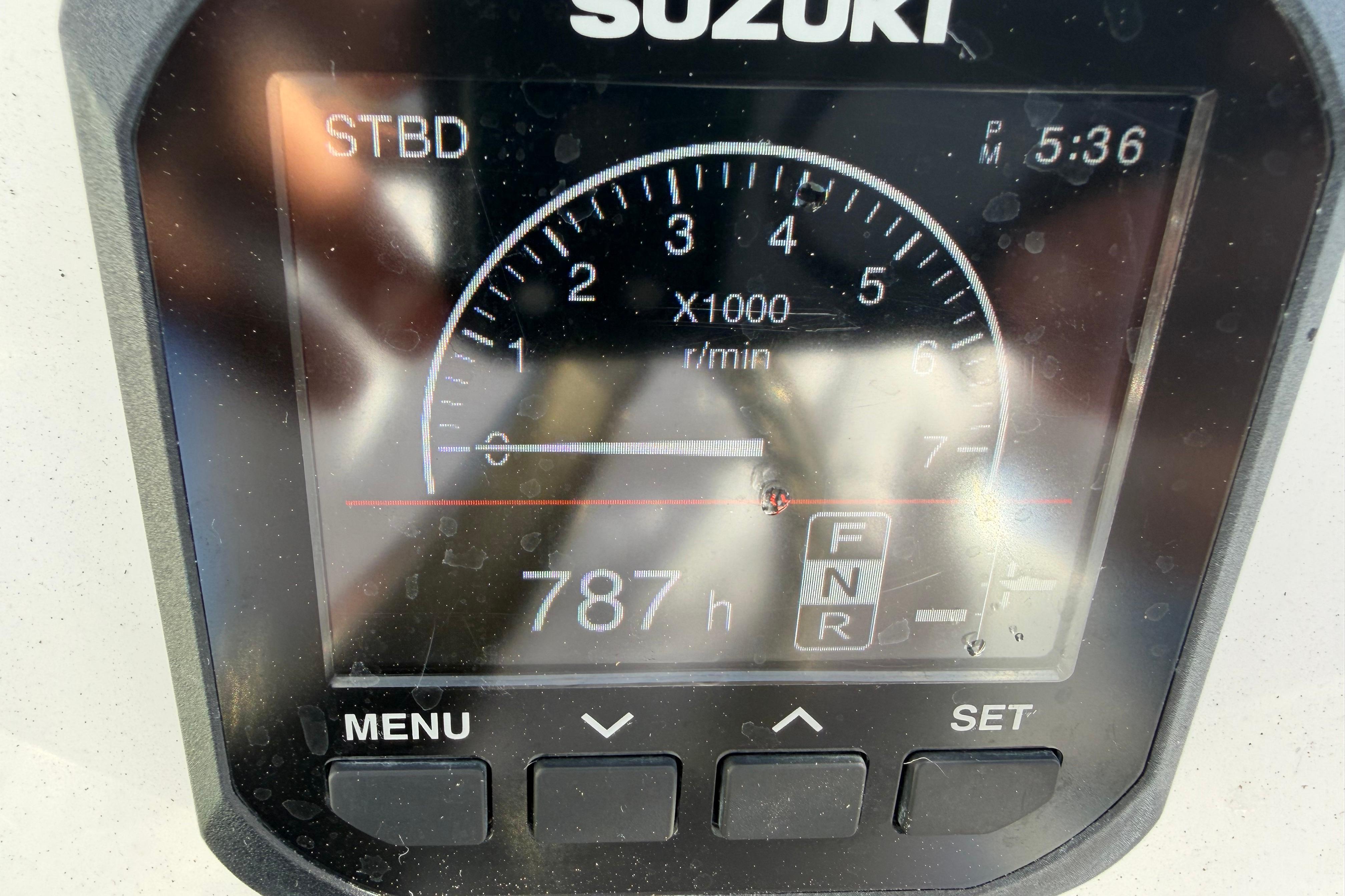Suzuki engine display showing 787 hours on a 2020 Tideline 235 Hybrid boat.