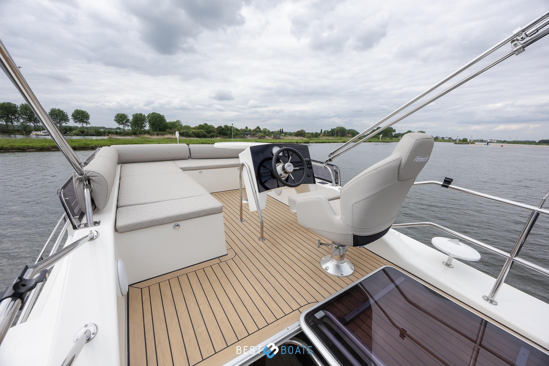 2023 Cobra Yachts Futura 36 Premium Fly, spacious deck with helm and seating, on calm waters.