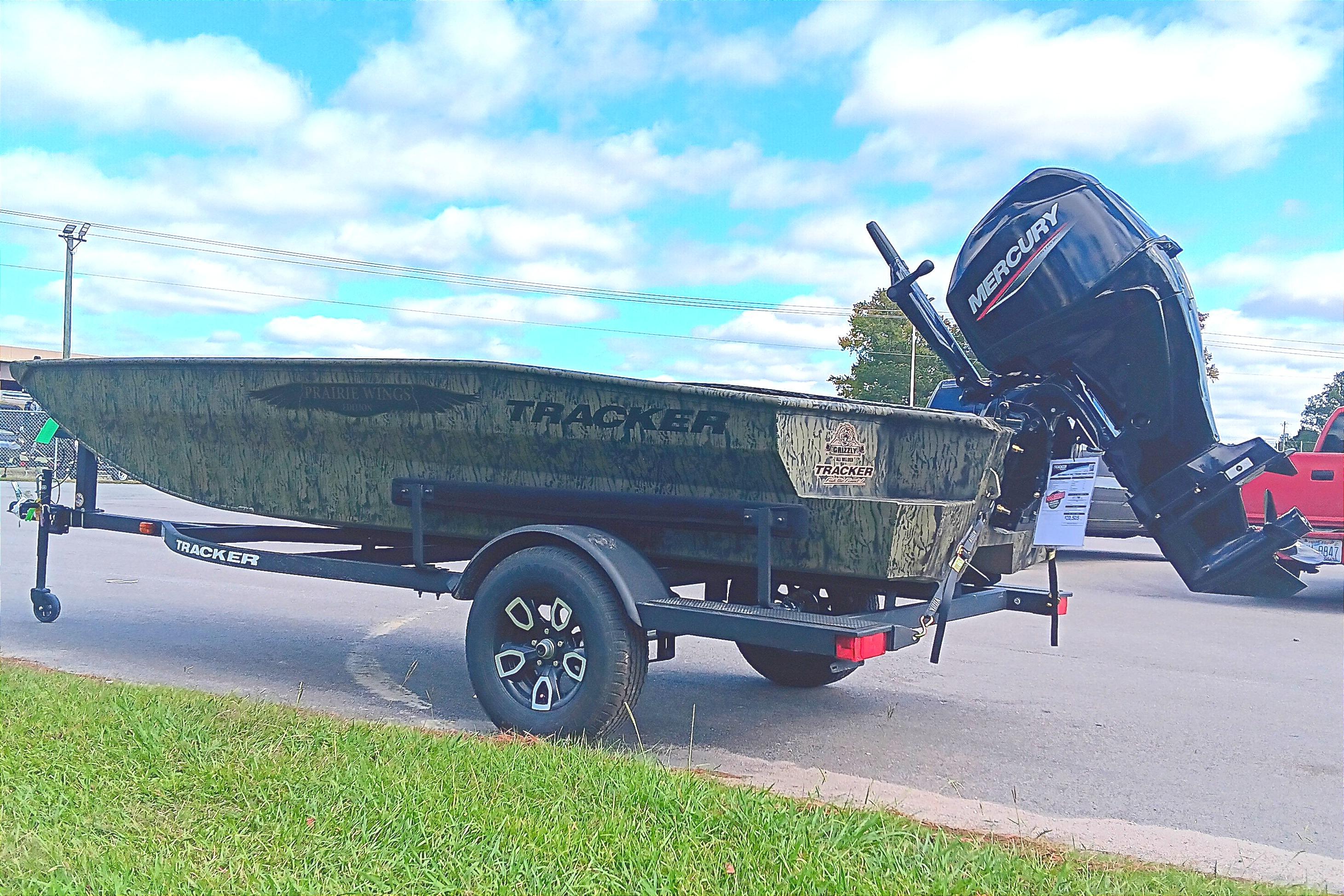 2026 Tracker Grizzly 1650 T Prairie Wings Edition boat on trailer, outdoors.