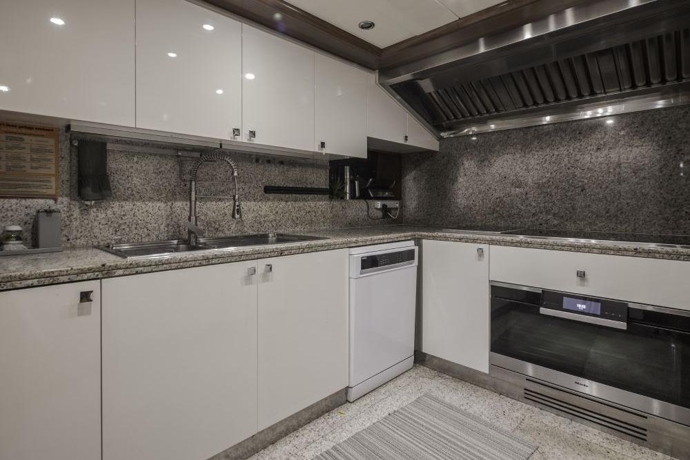 Luxurious yacht kitchen with modern appliances, granite countertops, and sleek white cabinetry, CRN 129, 2009.