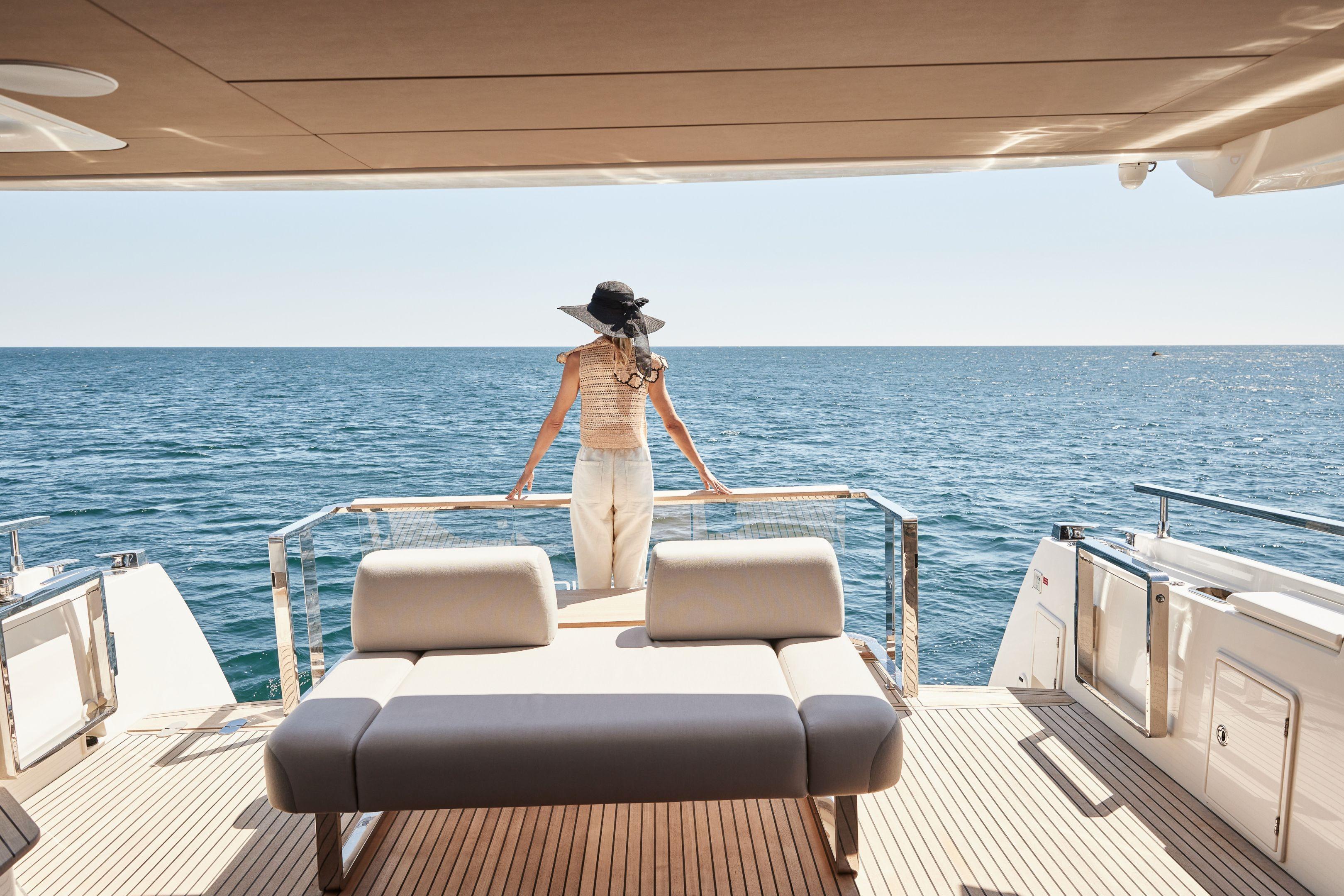 Woman enjoying ocean view on 2026 Prestige X60 yacht deck.