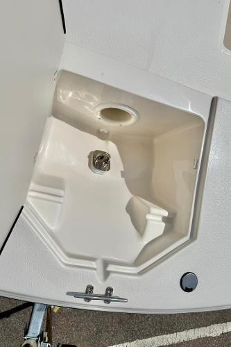 2025 Carolina Skiff 21 LS boat storage compartment, open and empty.
