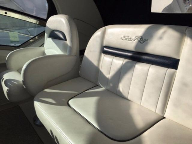 2004 Sea Ray 390 Sundancer interior with white leather seating and embossed logo.