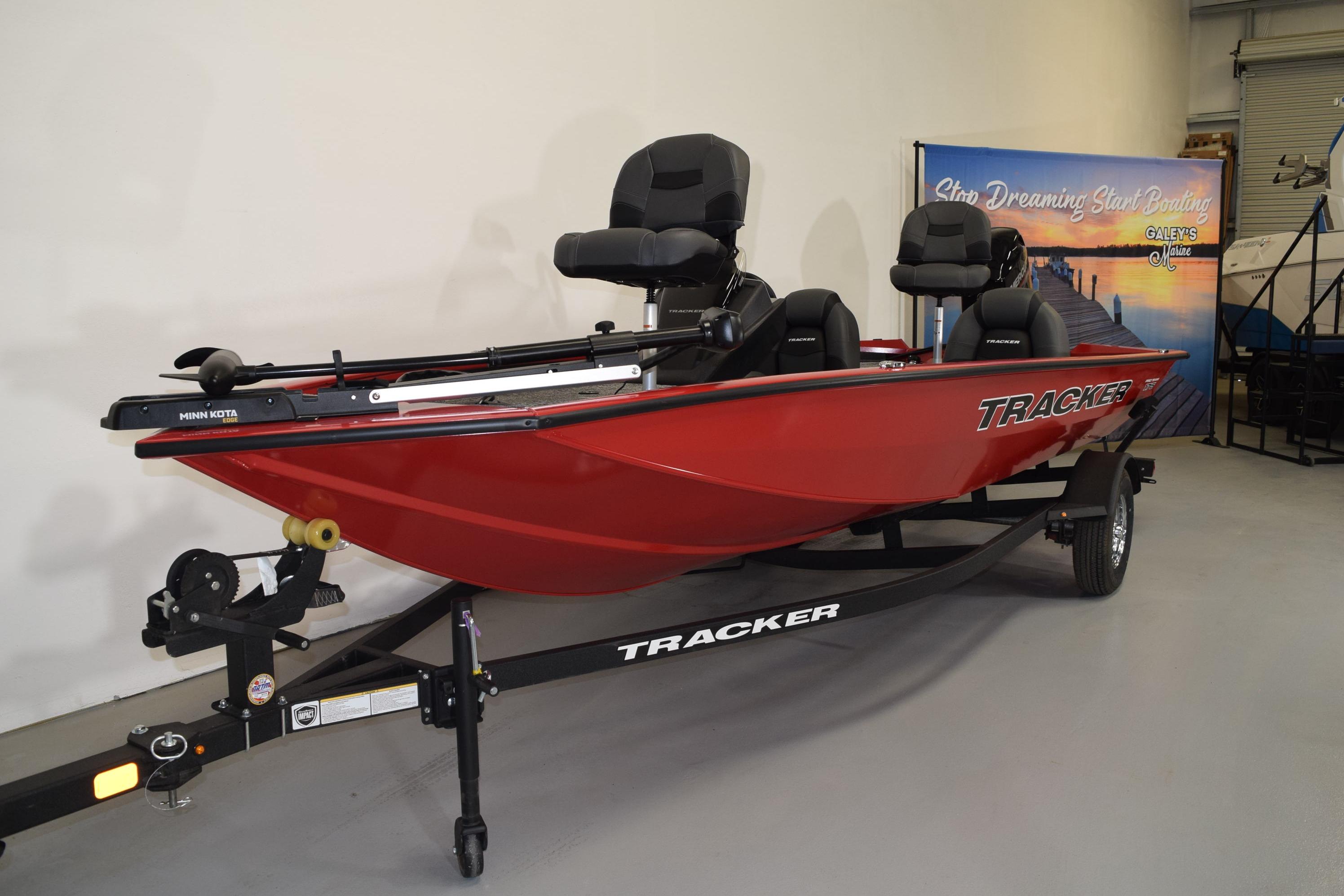 2026 Tracker Pro Team 175 boat in showroom, red exterior, on trailer.