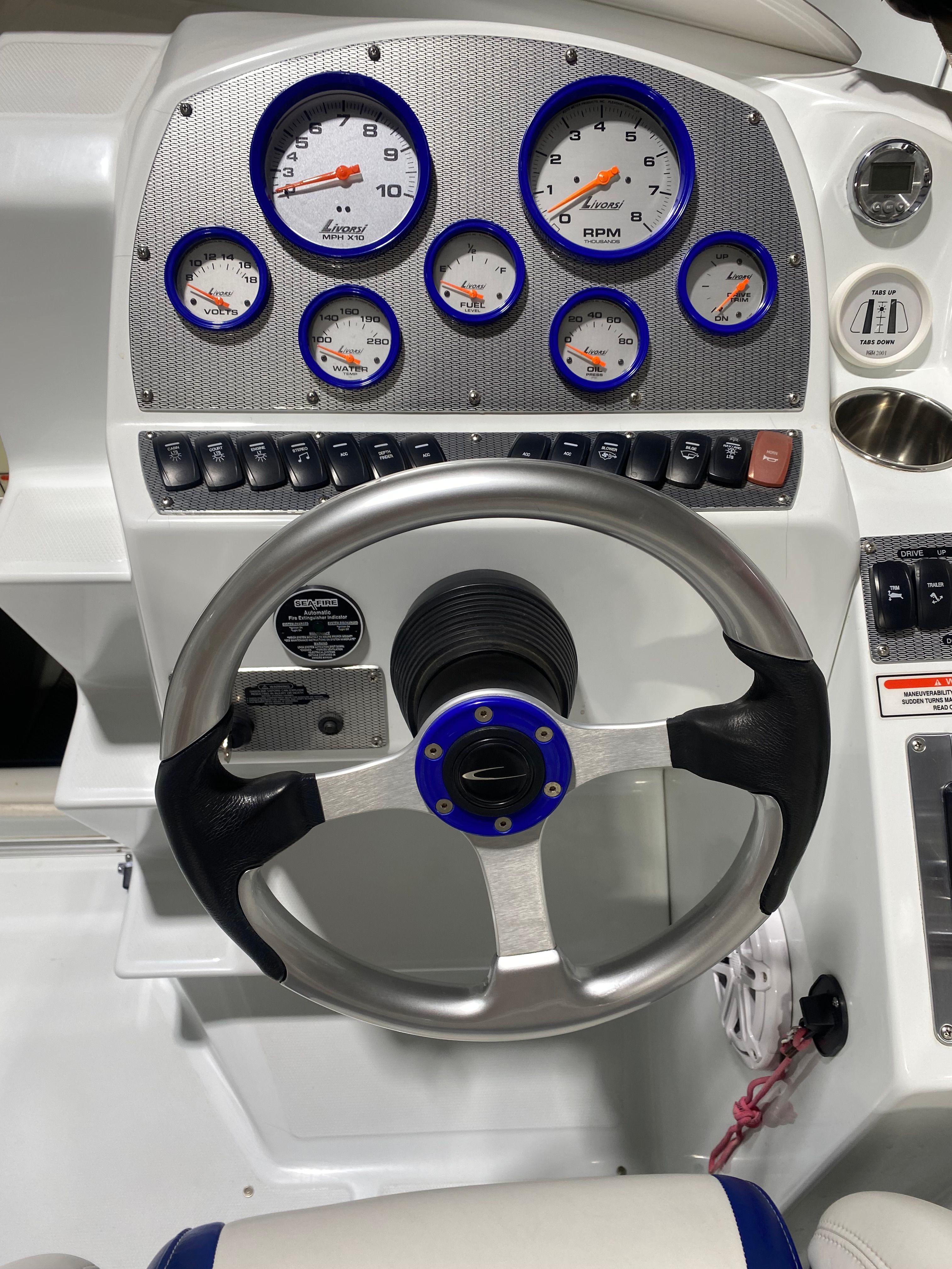 Dashboard of a 2005 Baja 23 Outlaw boat with gauges.