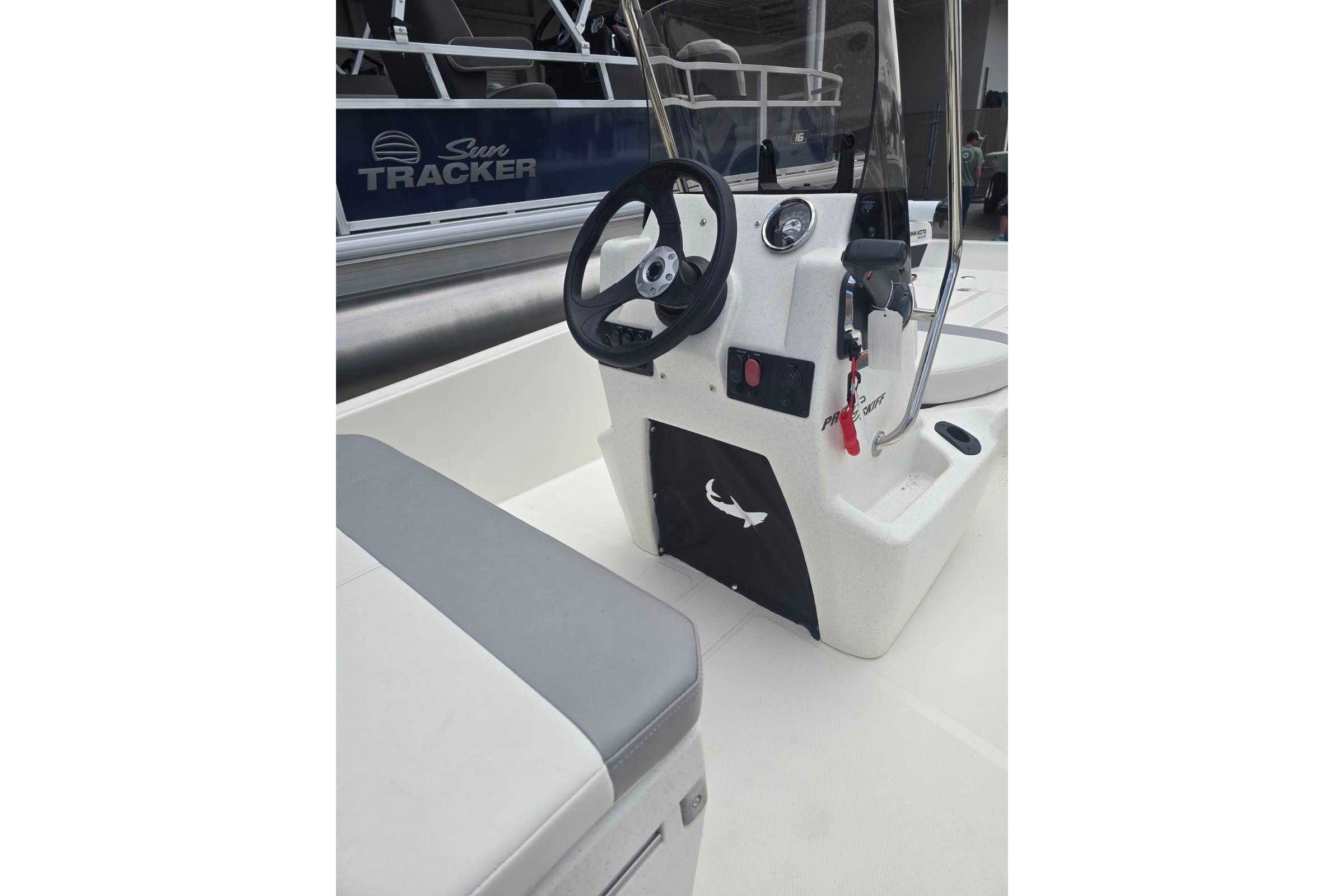 2026 Mako Pro Skiff 15 CC boat interior with steering console and seating.