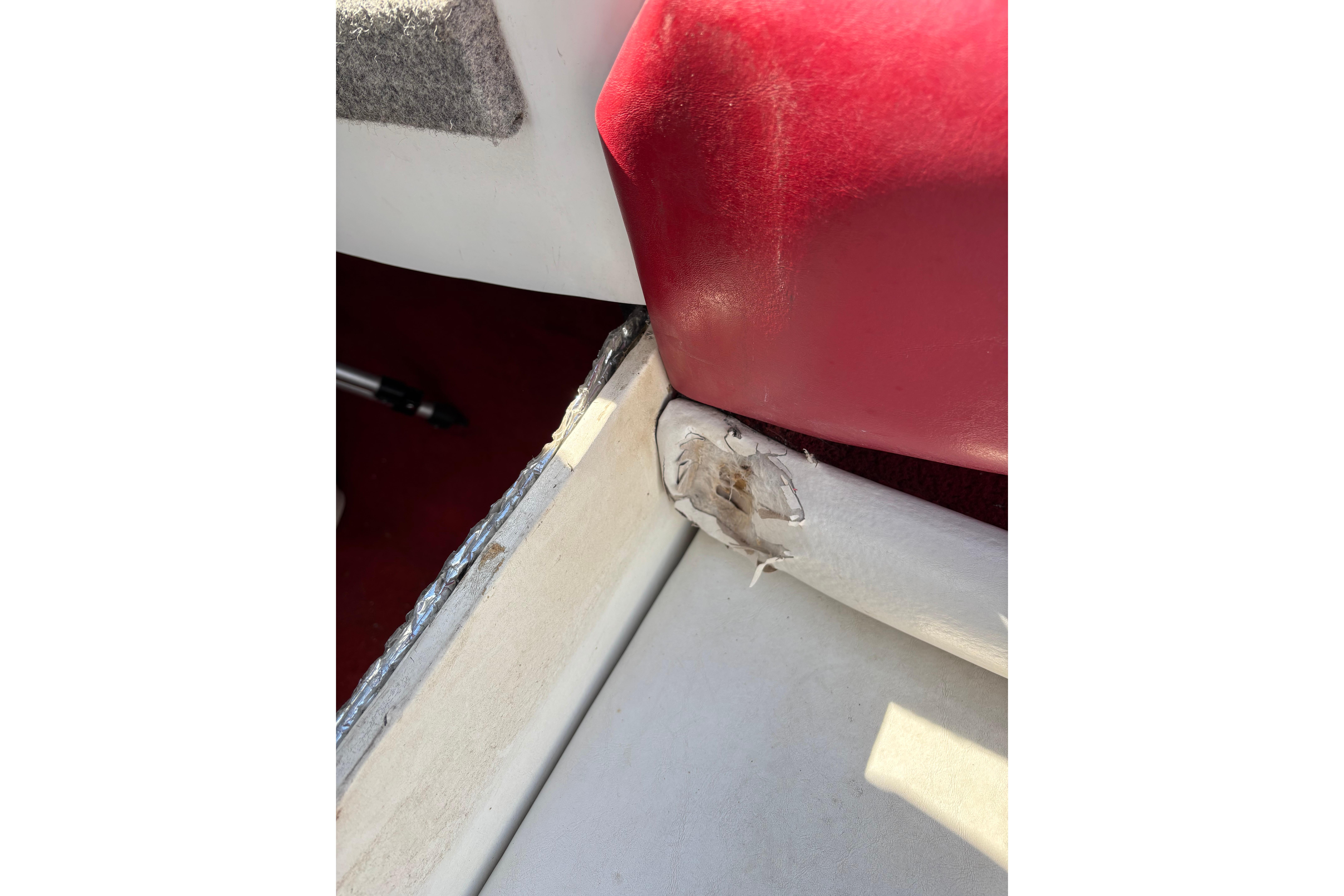 Damaged interior upholstery of a 1993 Larson SEi 200 Cuddy I/O boat.