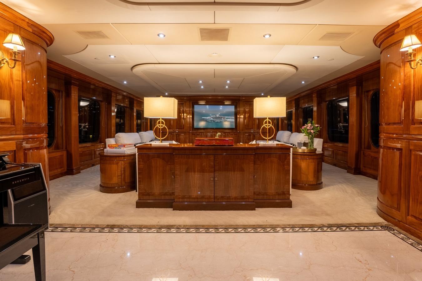 Luxurious interior of 2005 Christensen motor yacht with elegant wood paneling and ambient lighting.