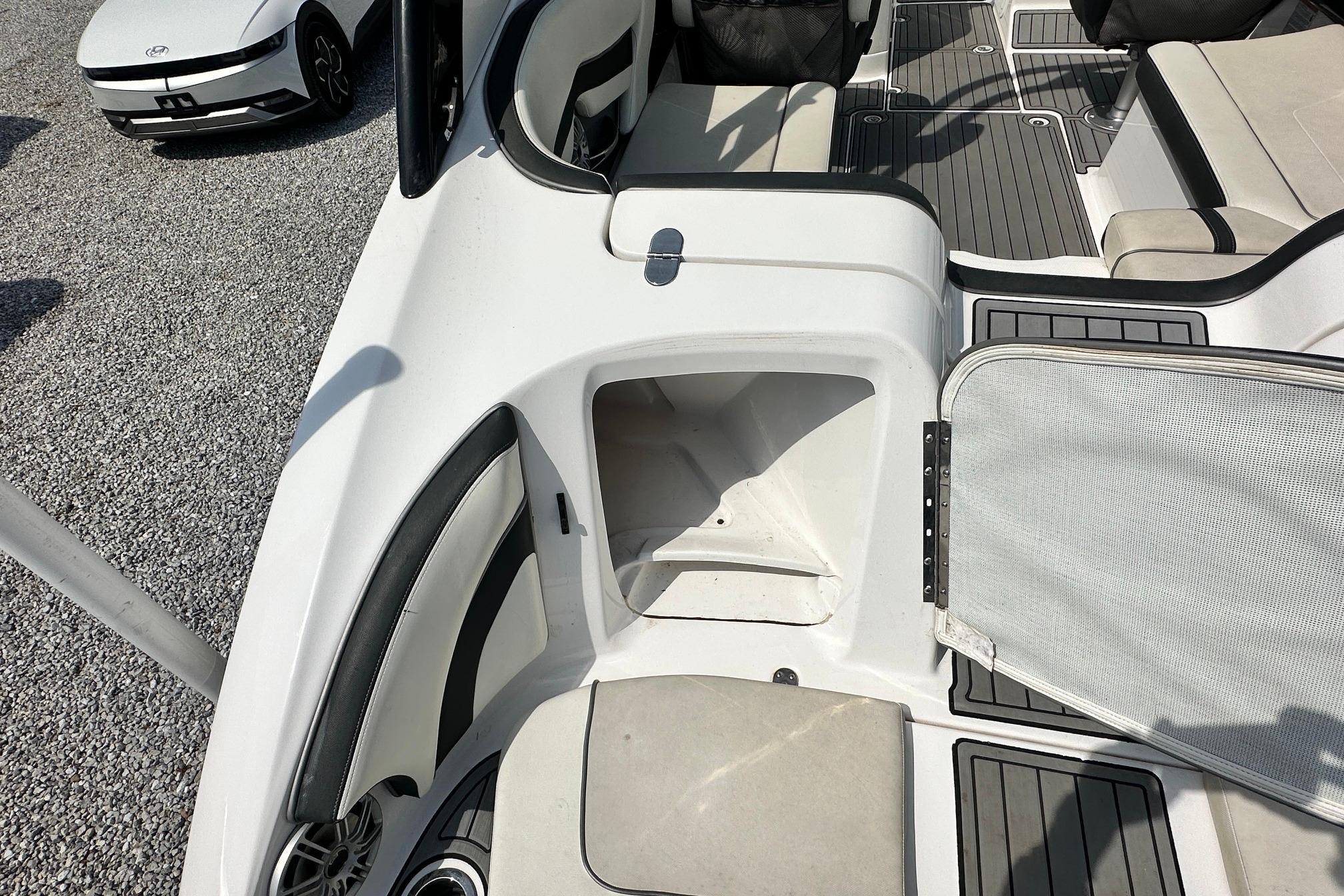 2016 Yamaha 242 Limited S boat interior with open storage compartment and seating.