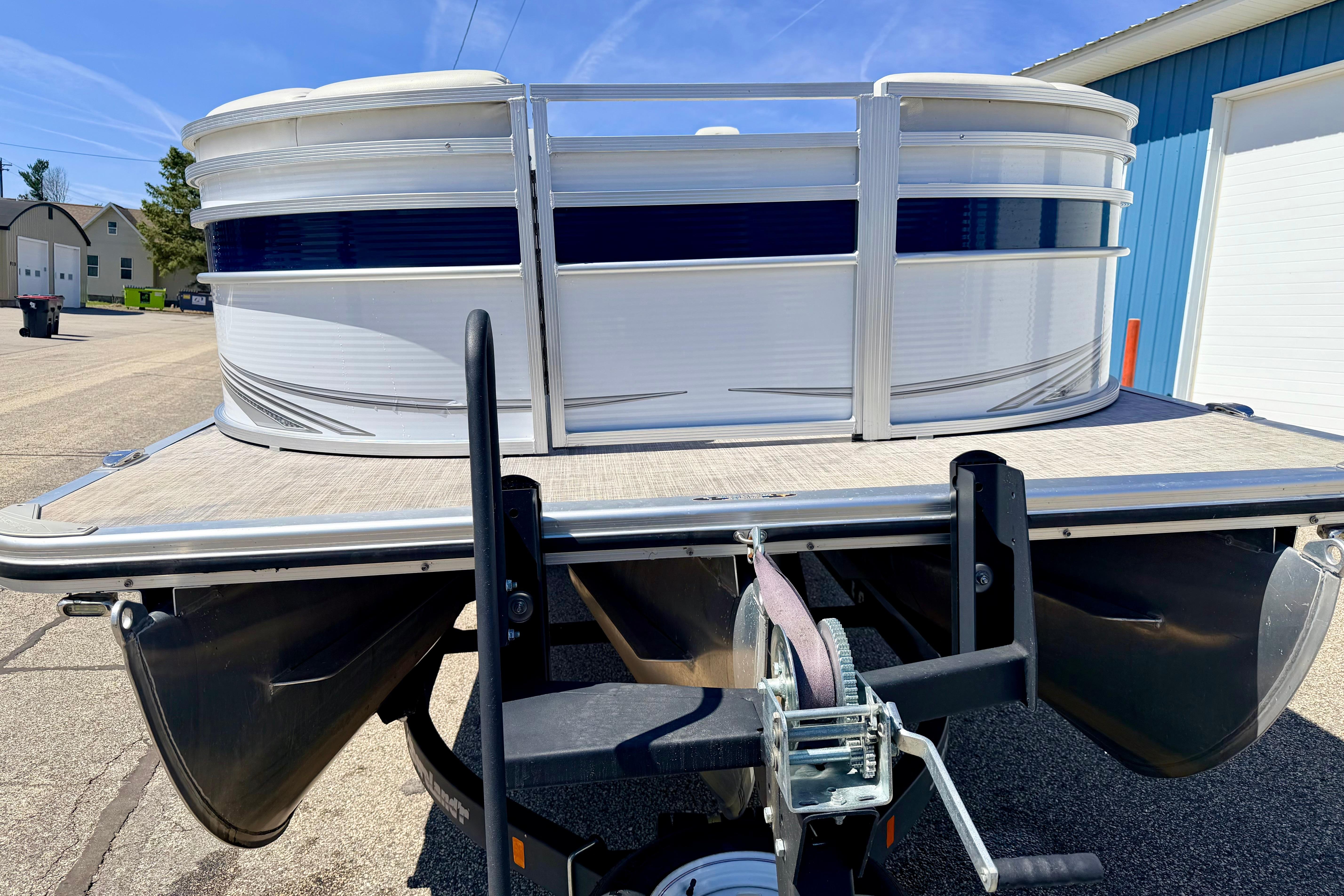 2019 Crestliner 240 Rally DX CW pontoon boat on trailer, parked outdoors.