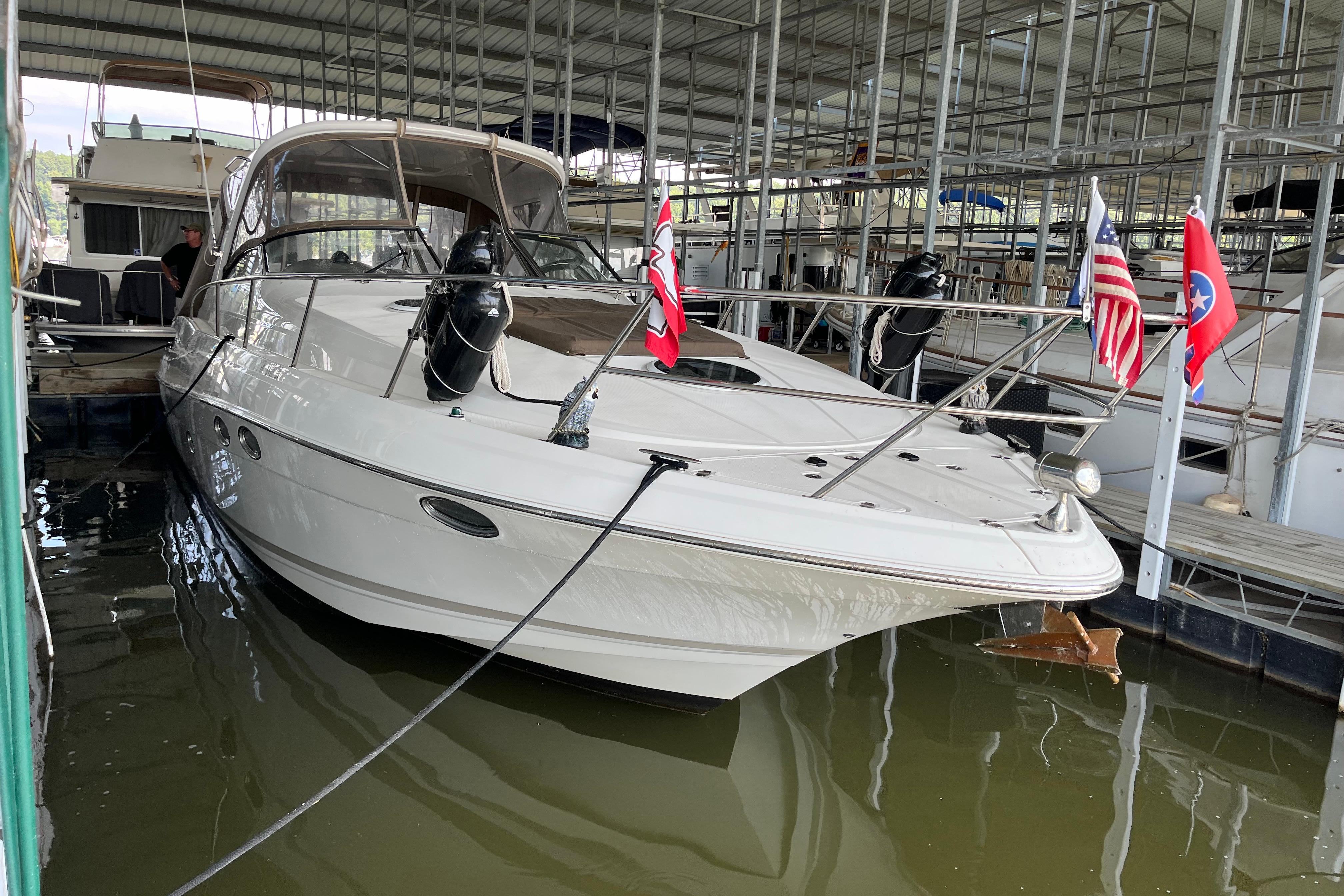 2007 Regal 3760 IB Commodore yacht docked with flags displayed.