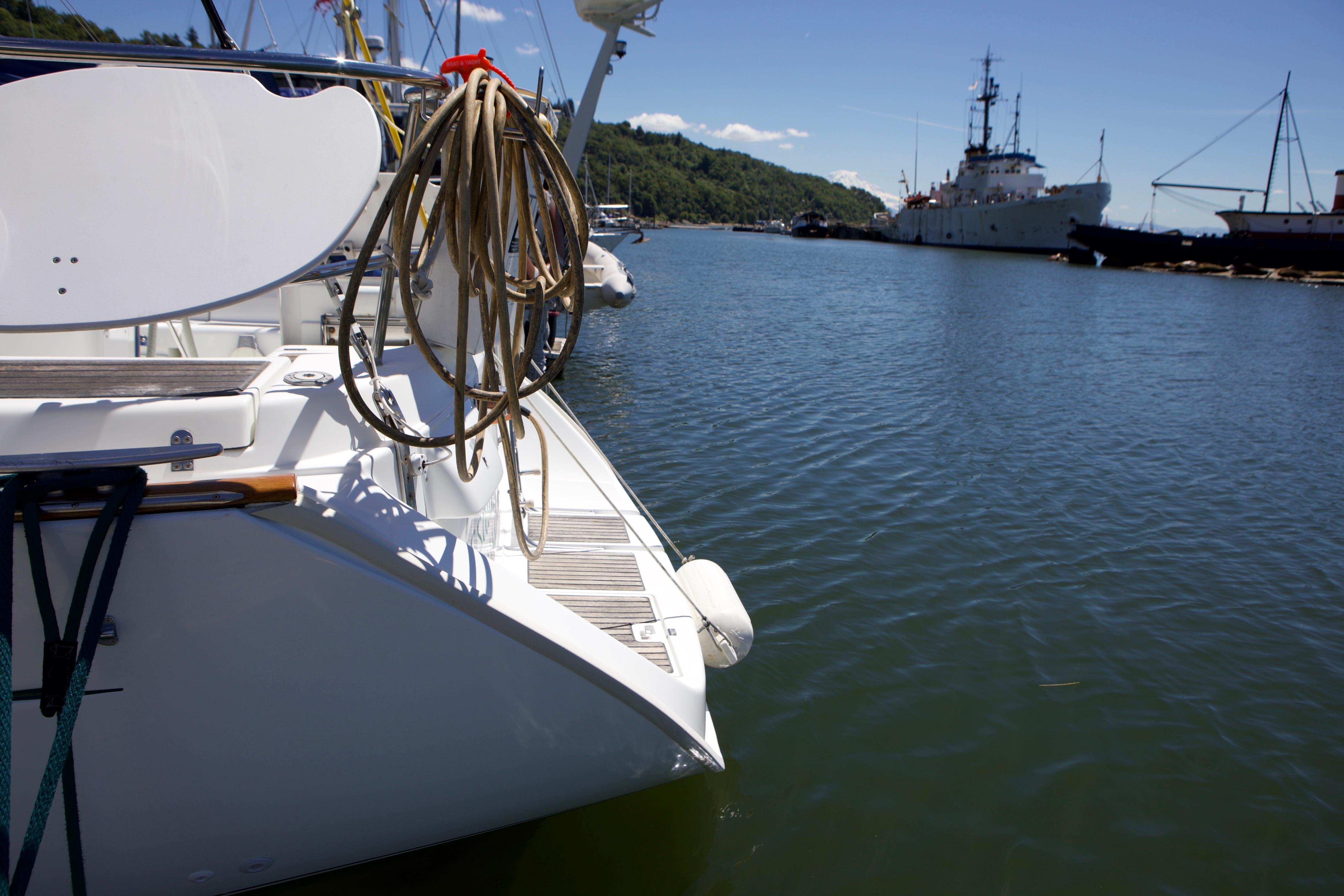 2005 Beneteau 423 yacht docked in a serene harbor with clear blue skies.
