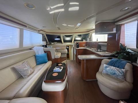 Luxurious interior of 2003 Sea Ray 480 Sedan Bridge yacht with elegant seating and modern kitchen.