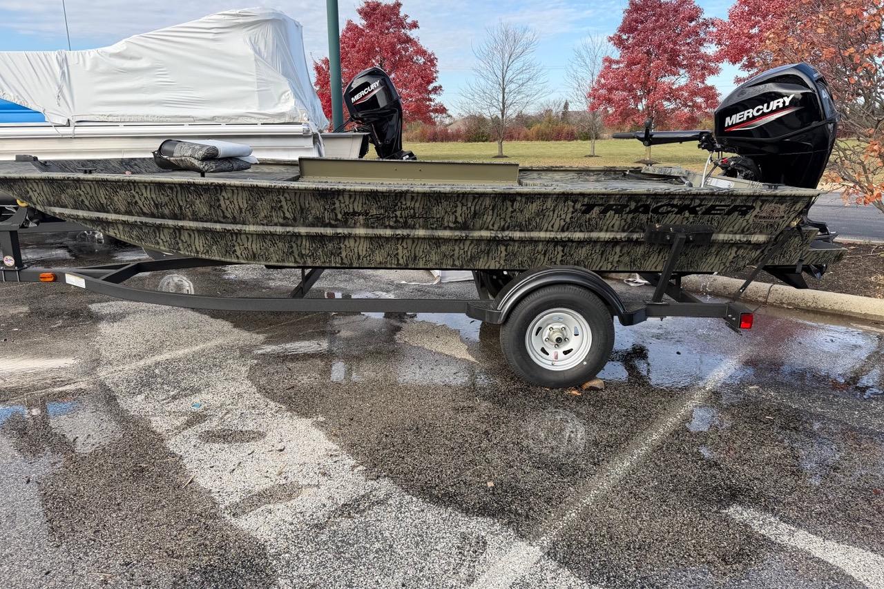 2026 Tracker Grizzly 1654 T Sportsman boat on trailer, parked outdoors.