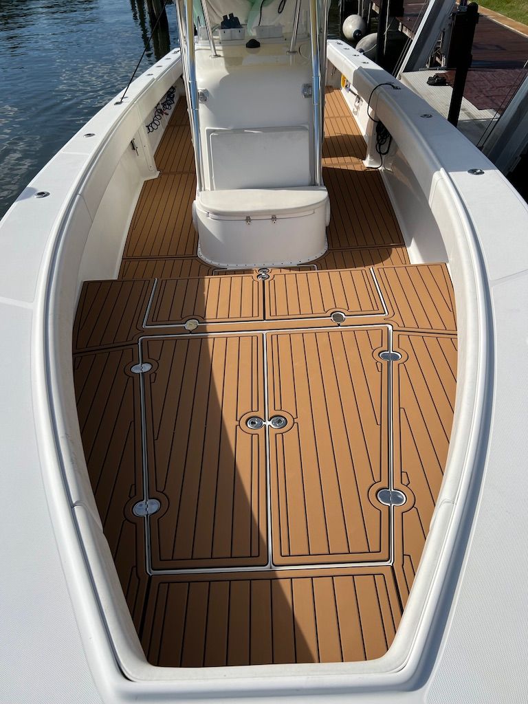 2006 Venture 39 Open boat with wooden deck and helm station.