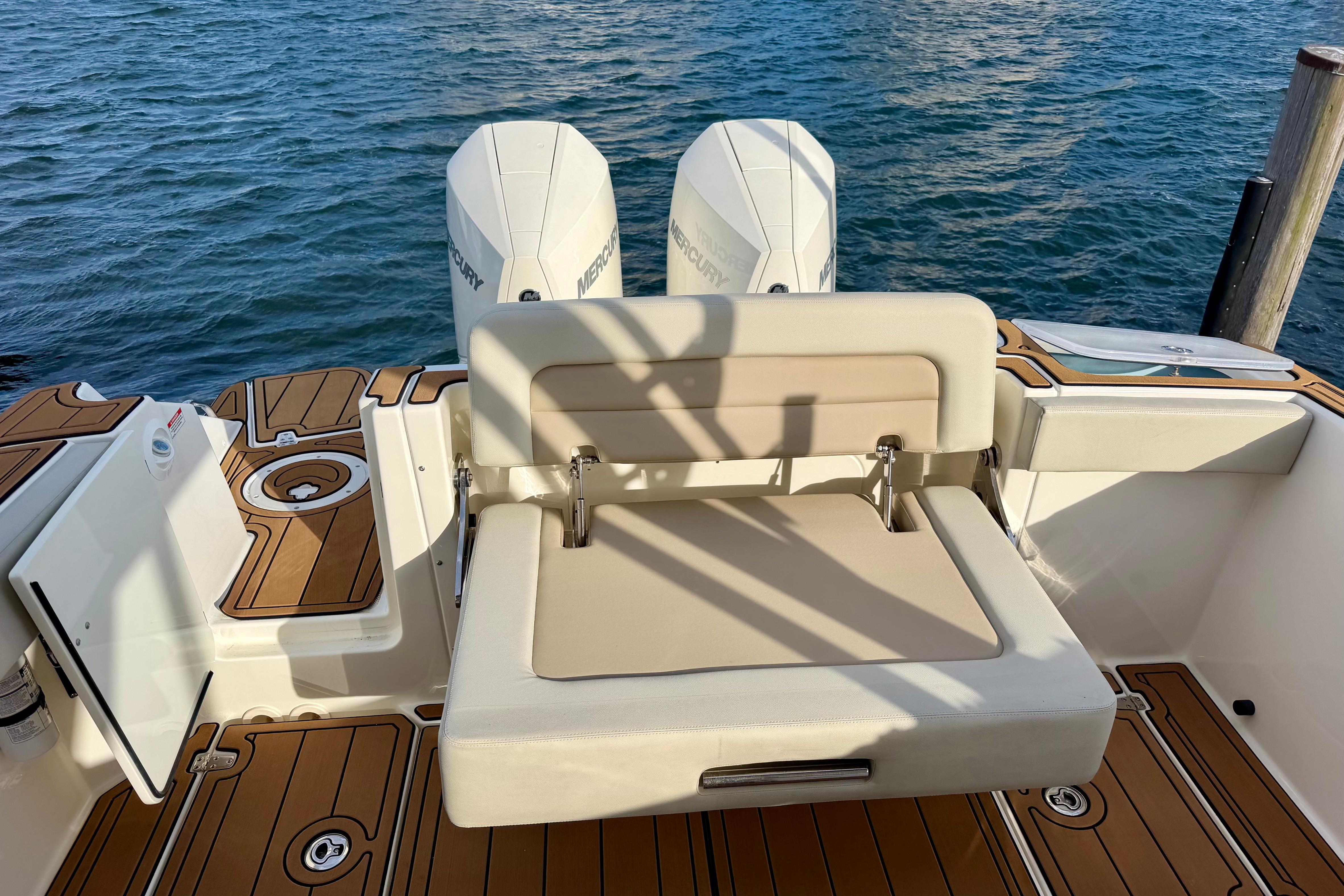 2022 Boston Whaler 280 Vantage boat with dual Mercury engines and cushioned seating.