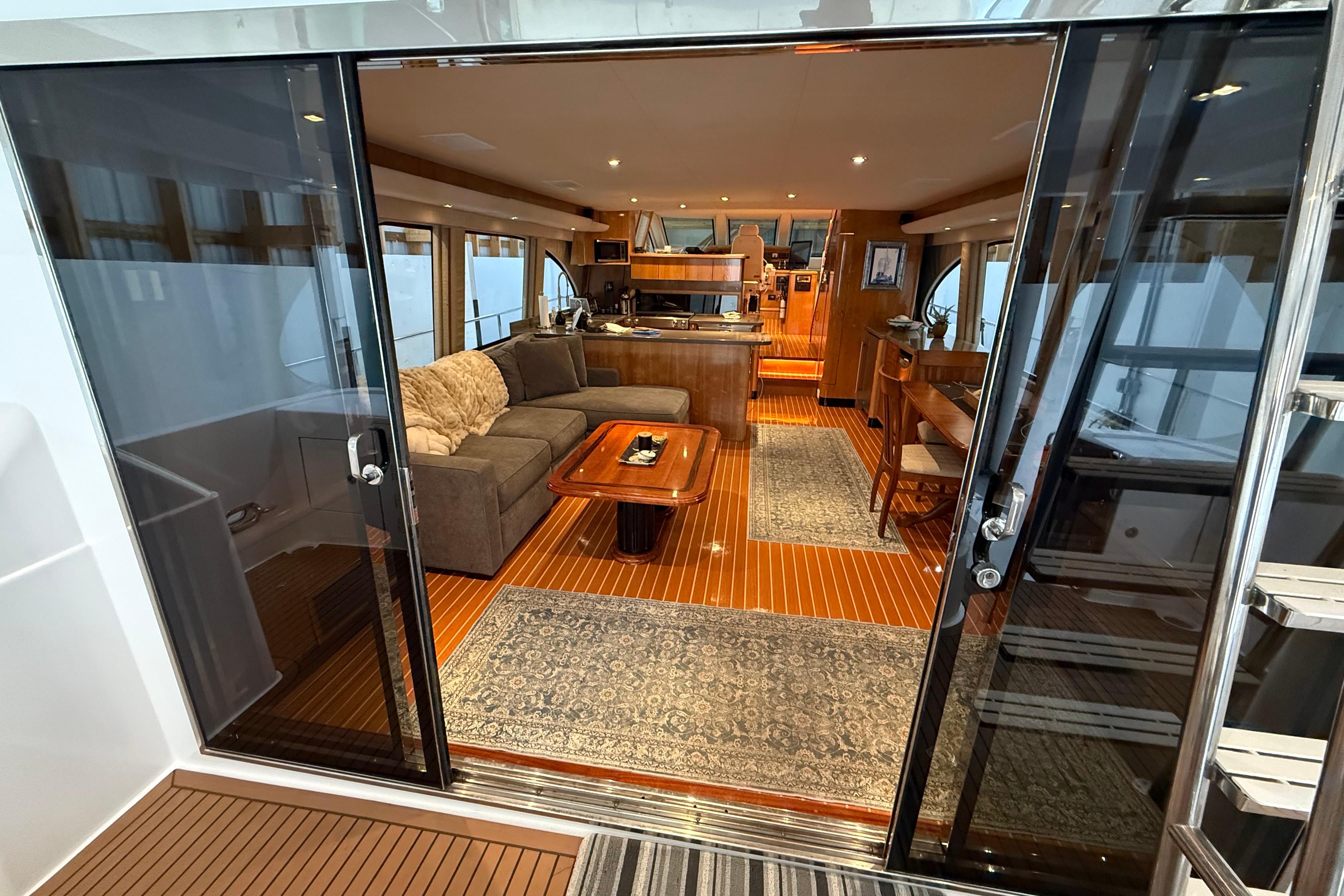 Luxurious interior of a 2000 Northern Pacific Motor Yacht with elegant wood flooring.